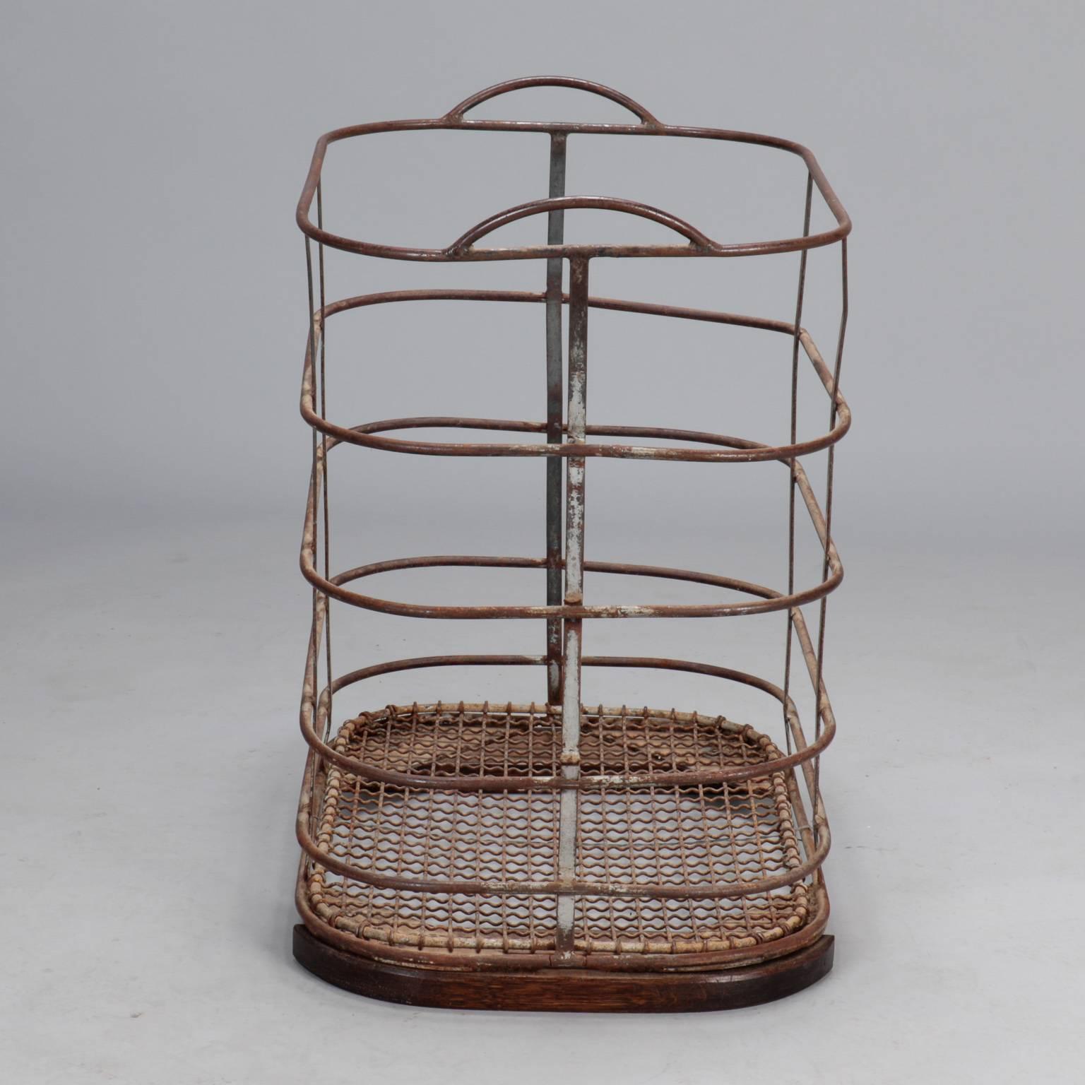 French industrial bin with rusted patina, mesh covered base and open work ribbed sides, circa 1900s. Handles on both sides at top. Originally from a factory.