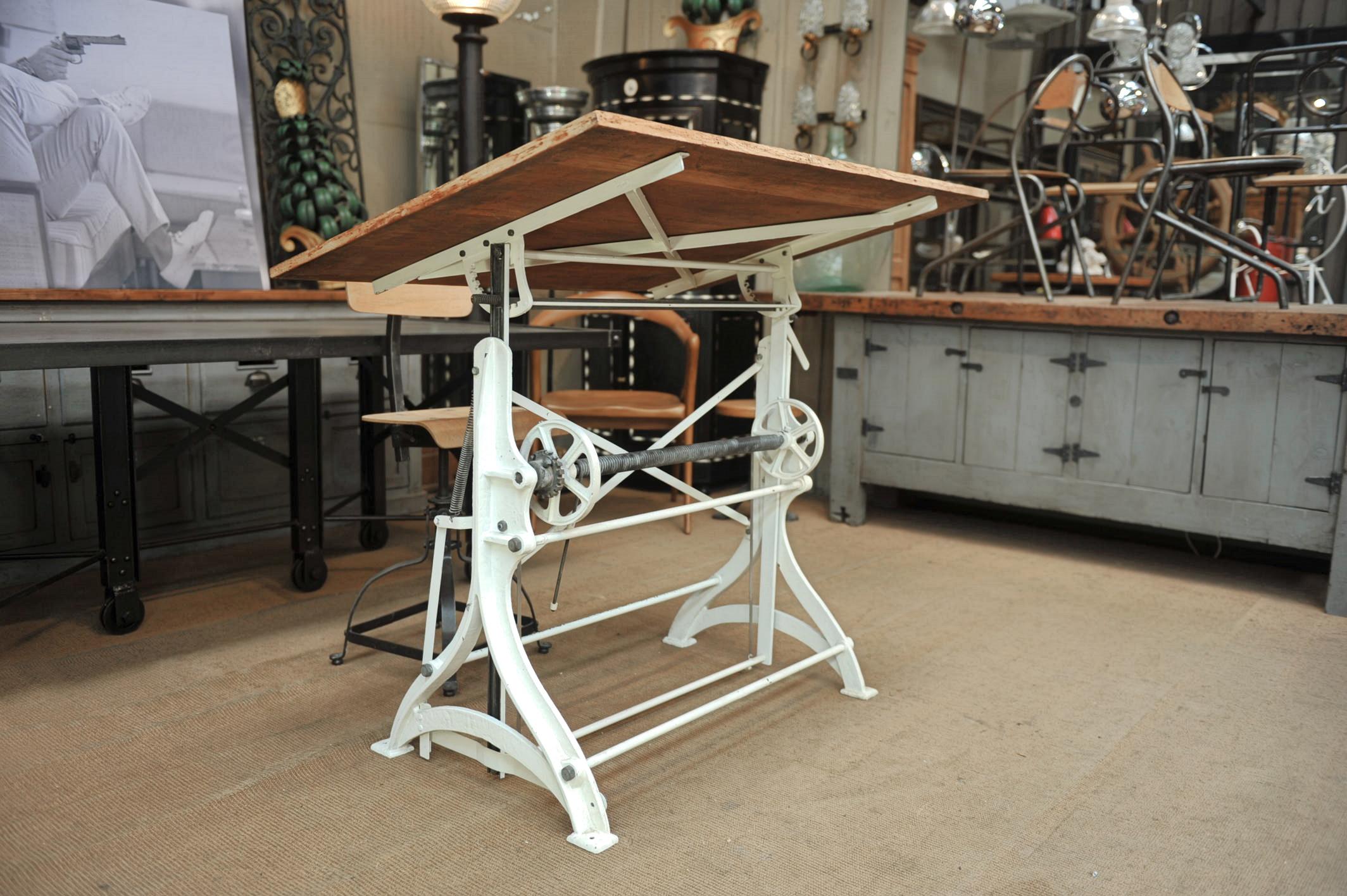 Pine top and white vintage color cast iron base French adjustable architect's drafting table , desk or writing Table very stable in horizontal or all desk position), circa 1900
goes up and down with foot pedal and lean very easily with side handle