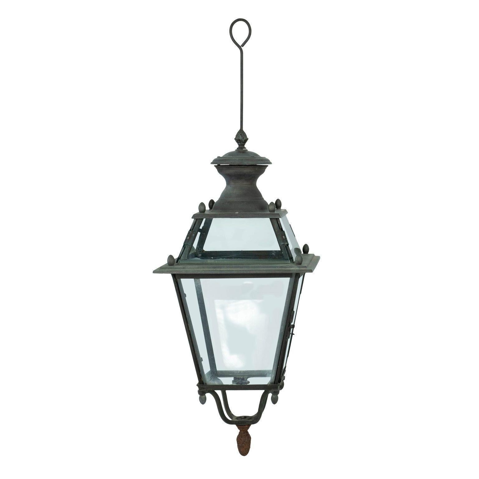 French iron and tole glass-paneled lantern circa 1870-1899. Unwired. Two lanterns are available but sold individually priced $3,800 each (see last image and item ref. 1023).

Note: Original/early finish on antique and vintage metal will include