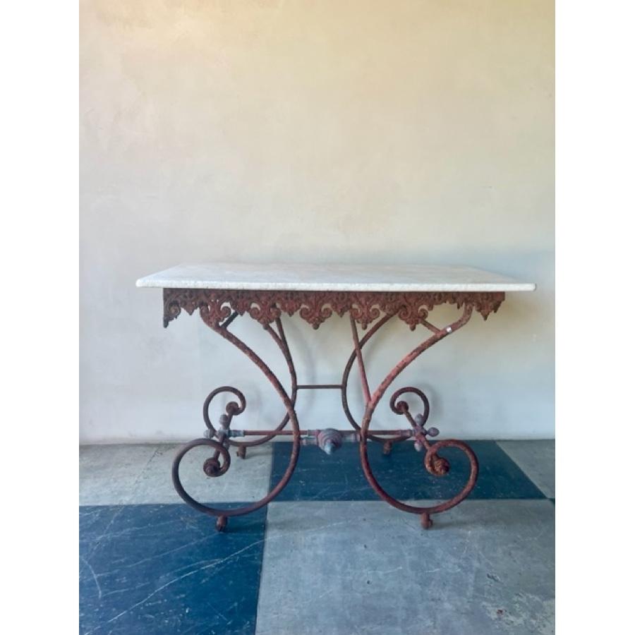 French Iron Baker's table topped with marble, 19th century

An elegant antique French red baker's table is topped with marble. The table has beautiful scroll and ironwork painted in a rustic red. A 3/4