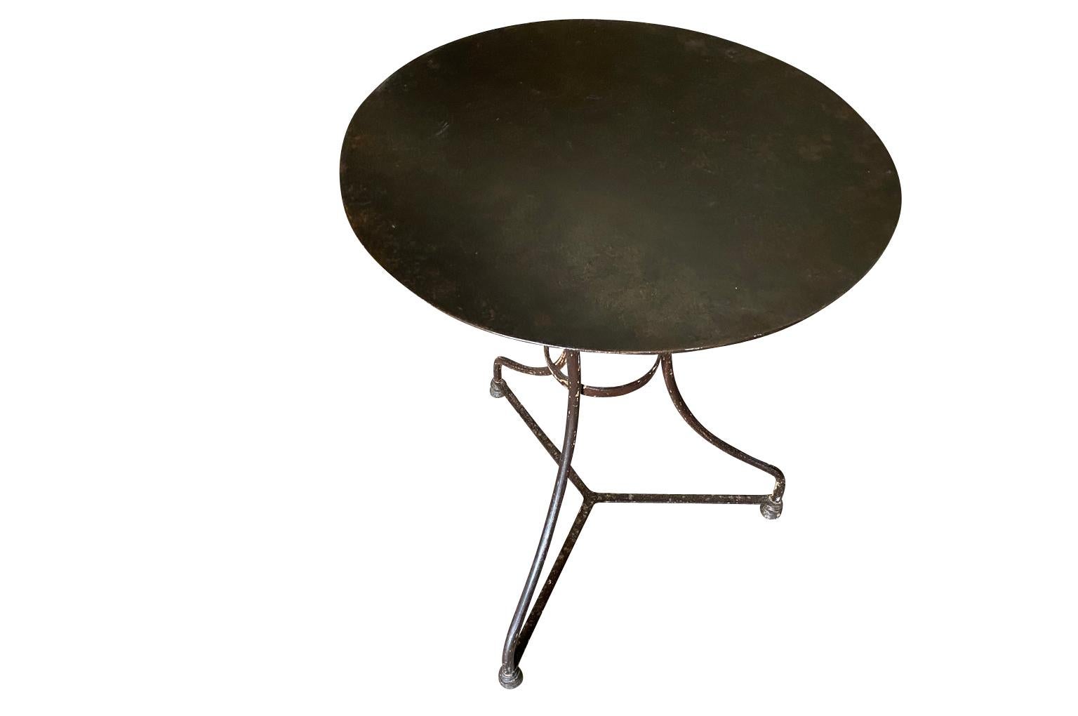 A very charming later 19th century Bistro Table from the South of France.  Soundly constructed from painted iron with a wonderful patina.  Perfect for any interior or garden.