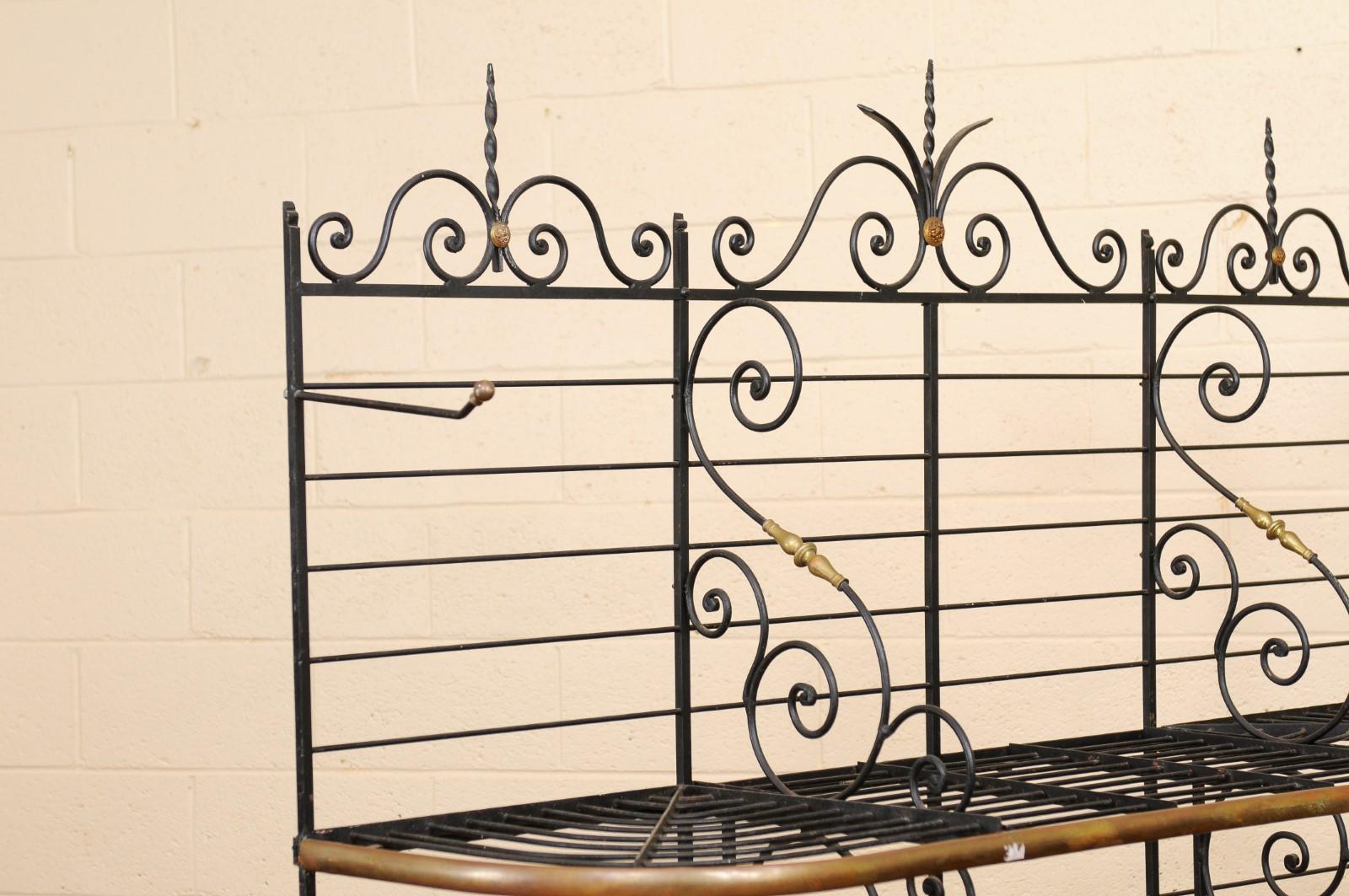 Large iron and brass baker's rack with three (3) shelves, two (2) hooks, and scroll detail, France circa 1890.