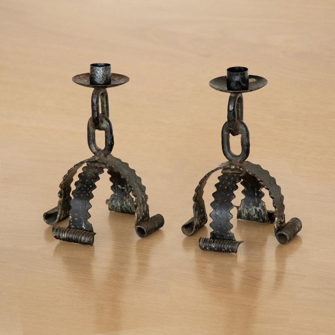 Vintage French black iron candlestick made of thick chain and four ornate metal legs. Surface shows great age and patina. Sold individually.
