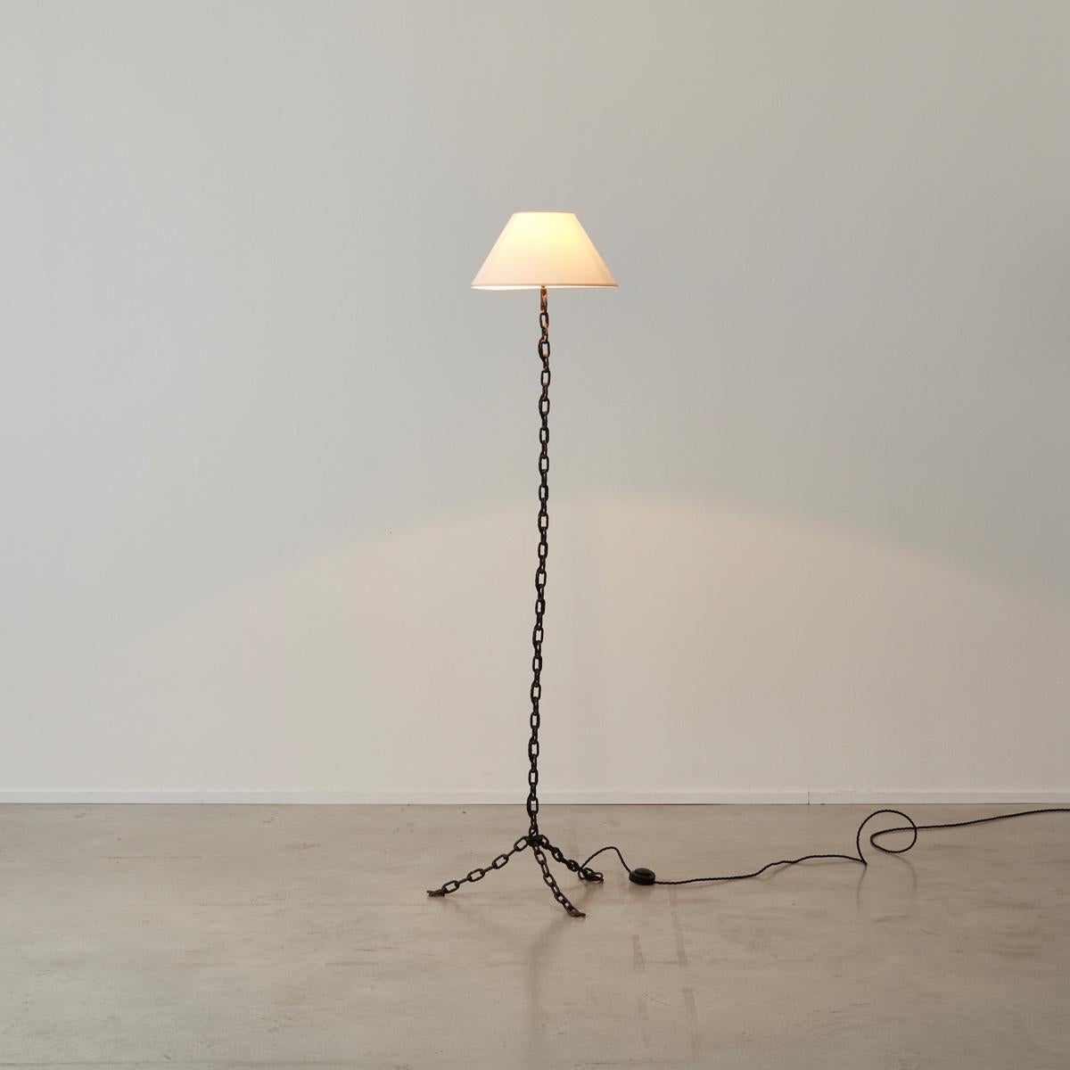 Enameled and welded black iron chain floor lamp, in the manner of artist Franz West.

Slight wear on material shade, slight rust and losses to paint/enamel coating.