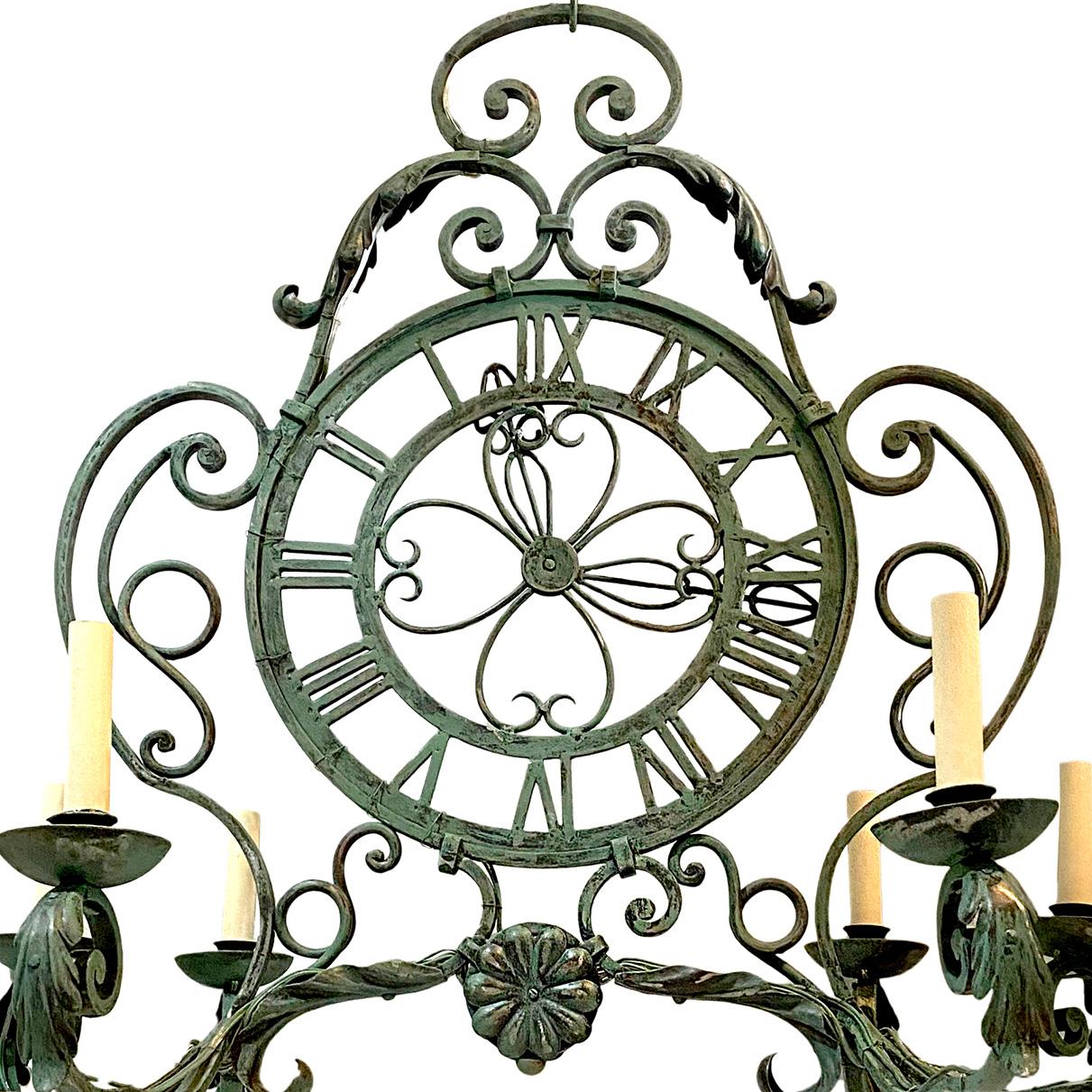 A circa 1940's French hammered iron clock ten-arm chandelier with original painted finish and patina.

Measurements:
Height of body: 32