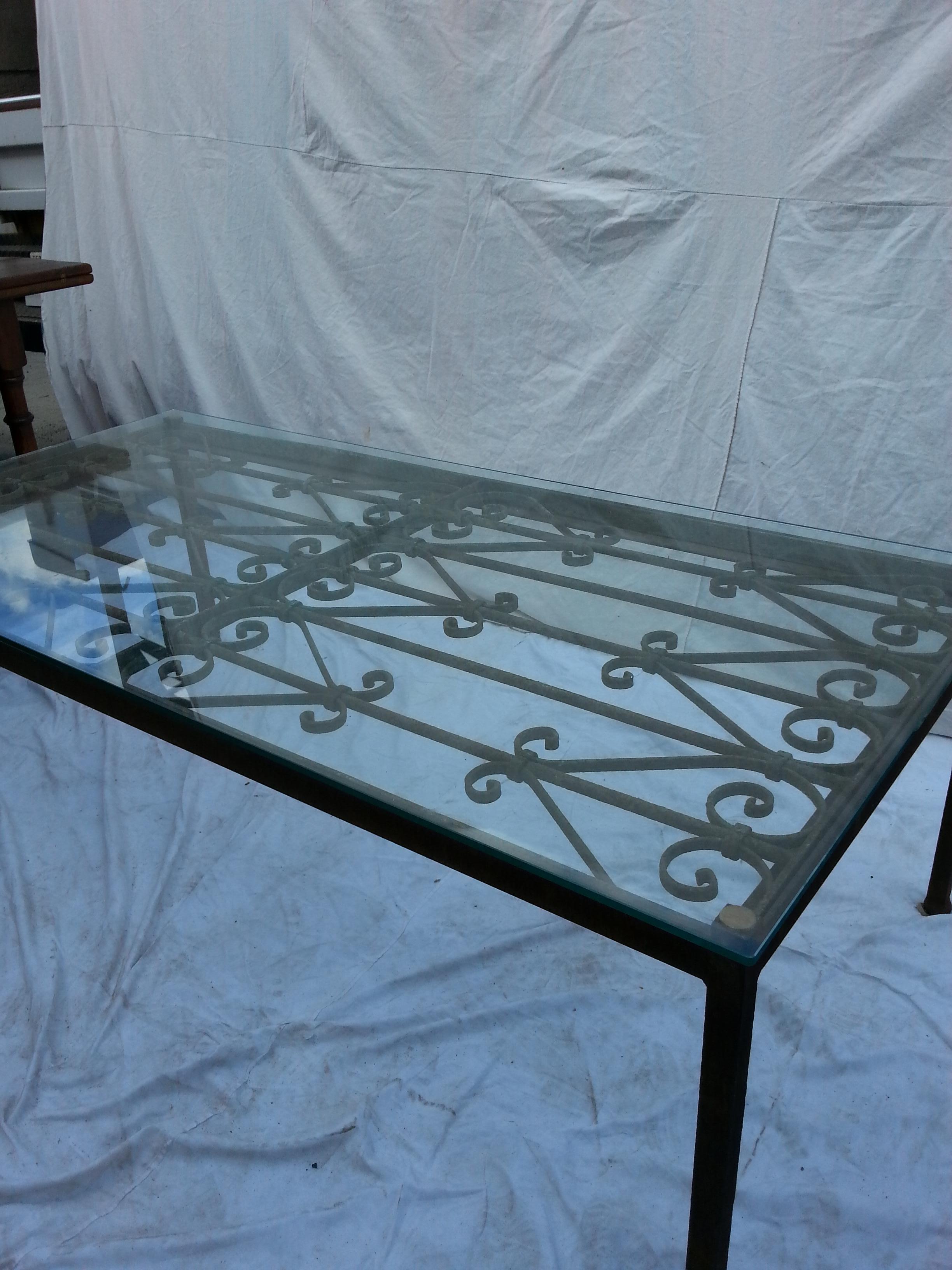 French iron coffee table with glass top.