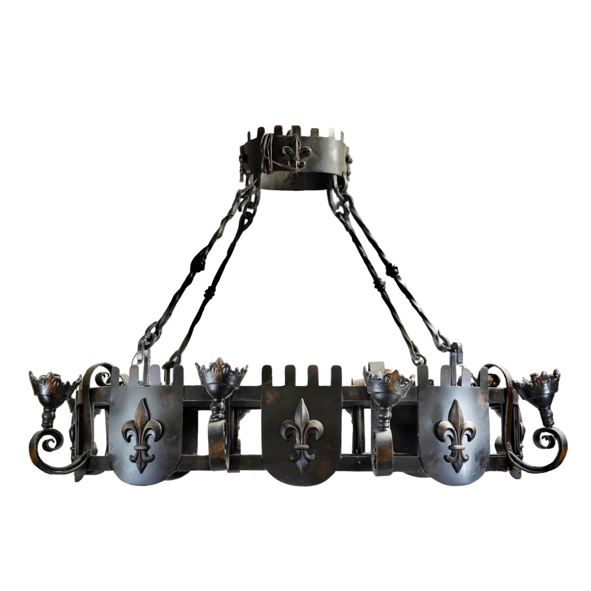 Enhance any room with our exquisite French Iron Chandelier. Crafted in France during the 1980s, this chandelier features intricate ironwork and iconic fleur de lis symbols. With a hardwired installation and an elegant design, it is perfect for