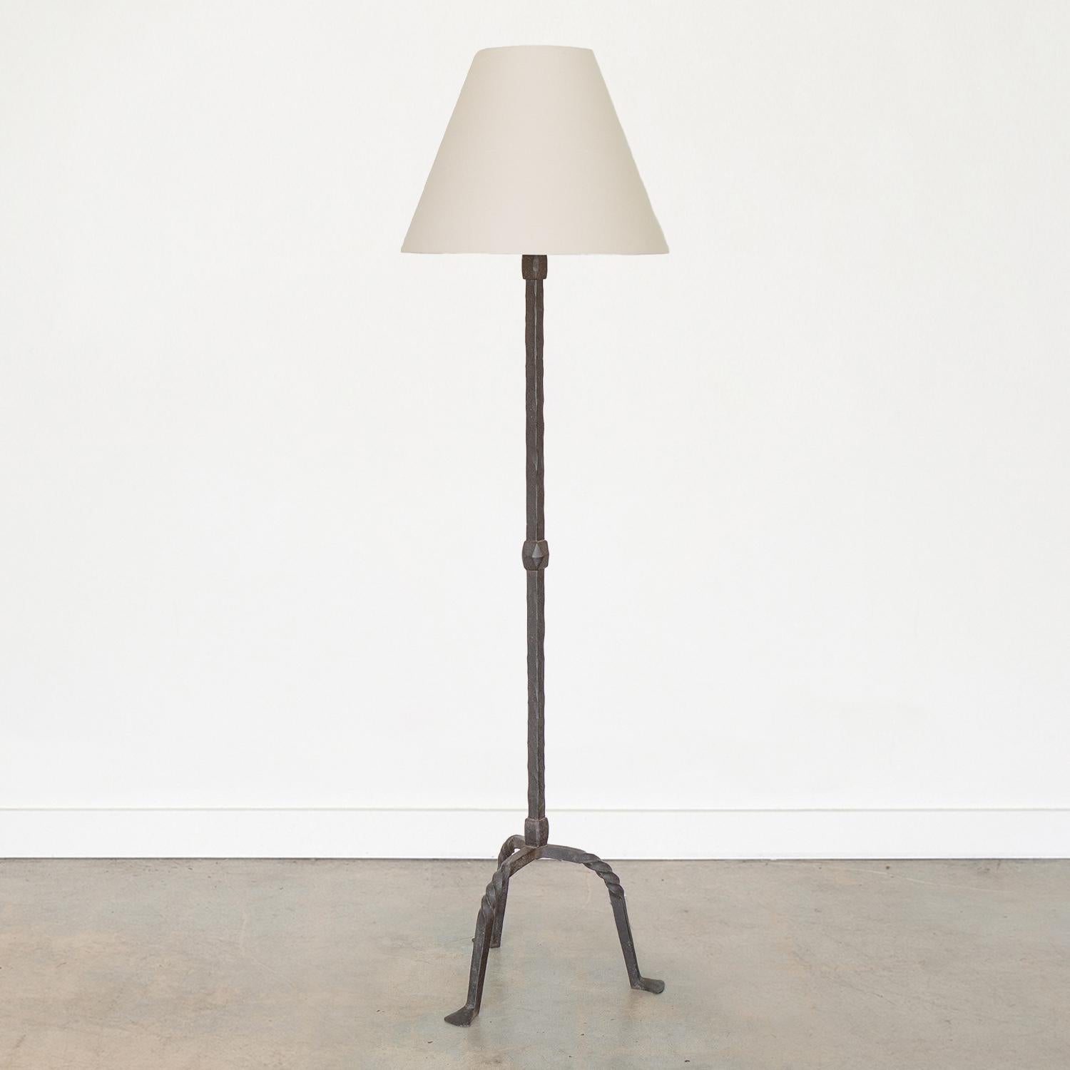 Incredible vintage wrought iron floor lamp from France, 1940s. Heavy thick iron stem with three leg twisted iron arched base. New linen tapered shade and newly re-wired. 


