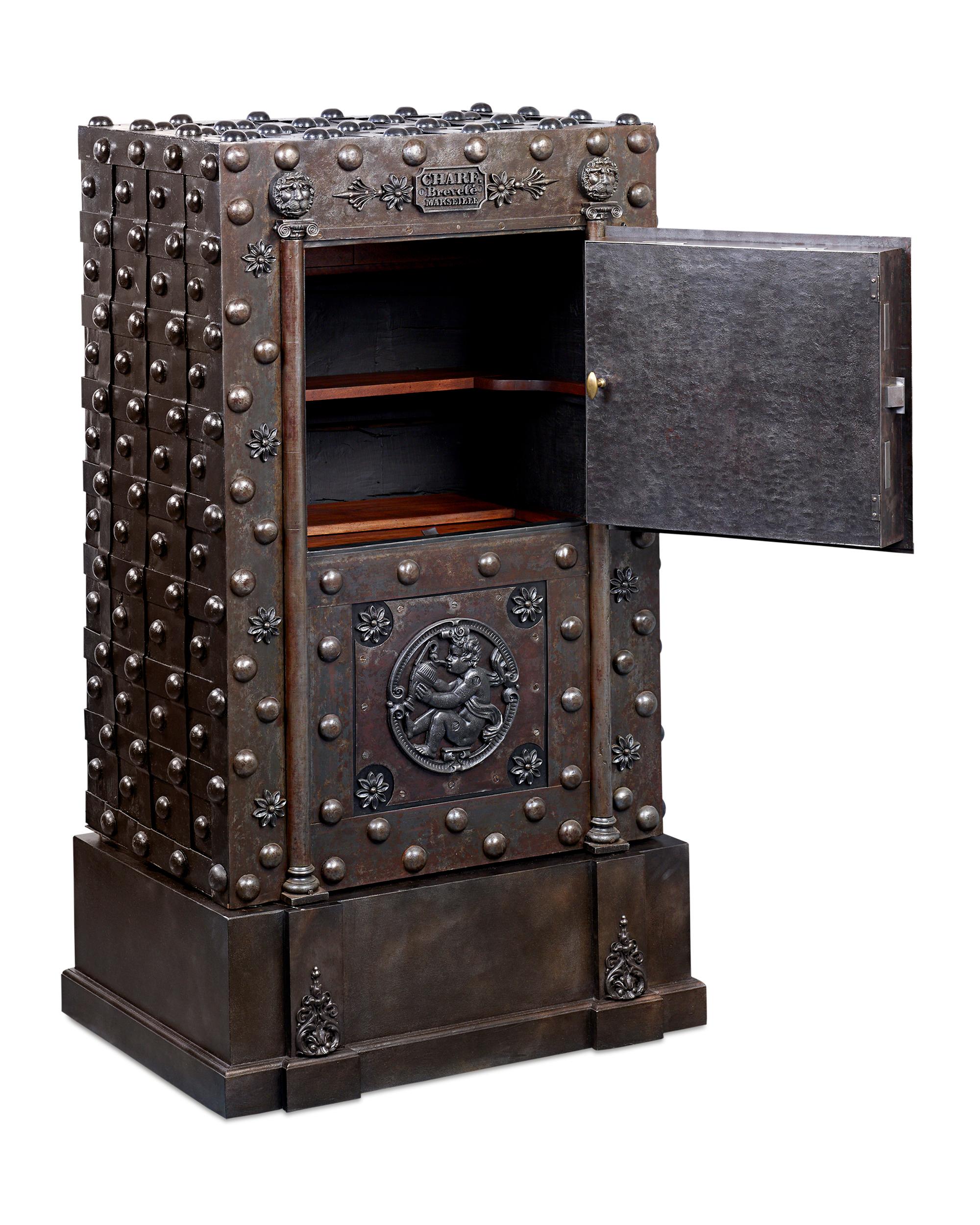A marvel of mechanical complexity and exceptional craftsmanship, this fully functioning French hobnail safe was one of the most secure means by which valuables could be stored in the 19th century. Weighing nearly 700 pounds, the iron structure is