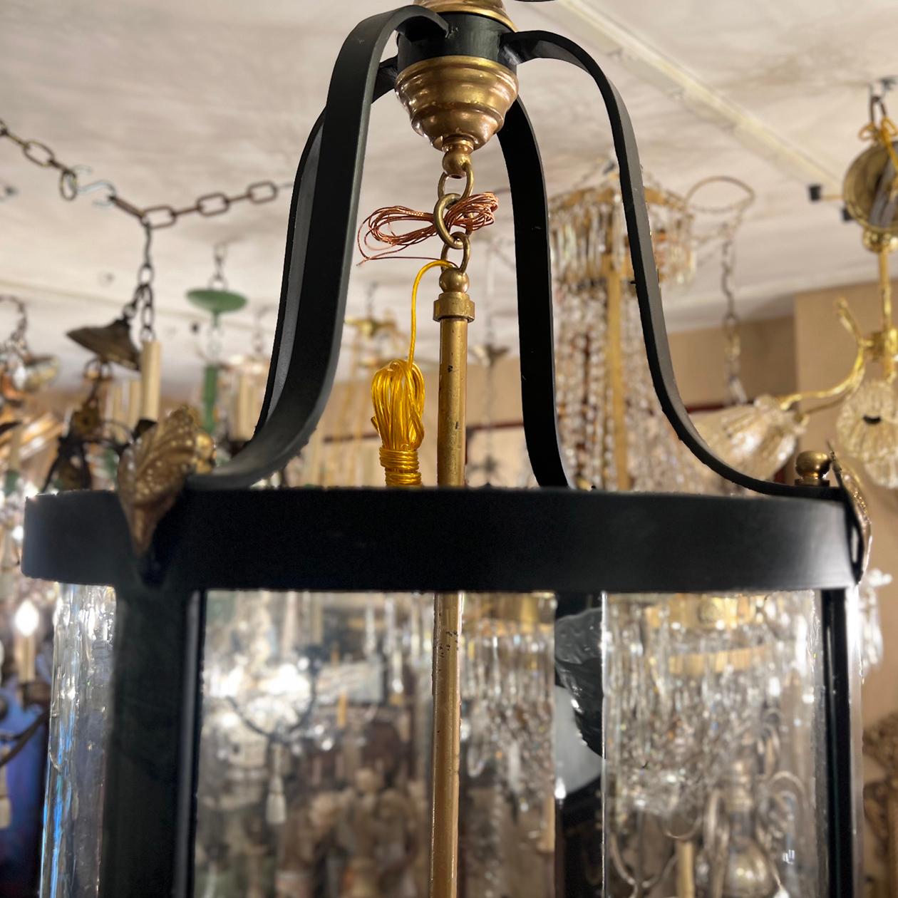 A circa 1920’s French iron lantern with gilt details and six interior candelabra lights.

Measurements:
Height of body:36″
Present drop: 43