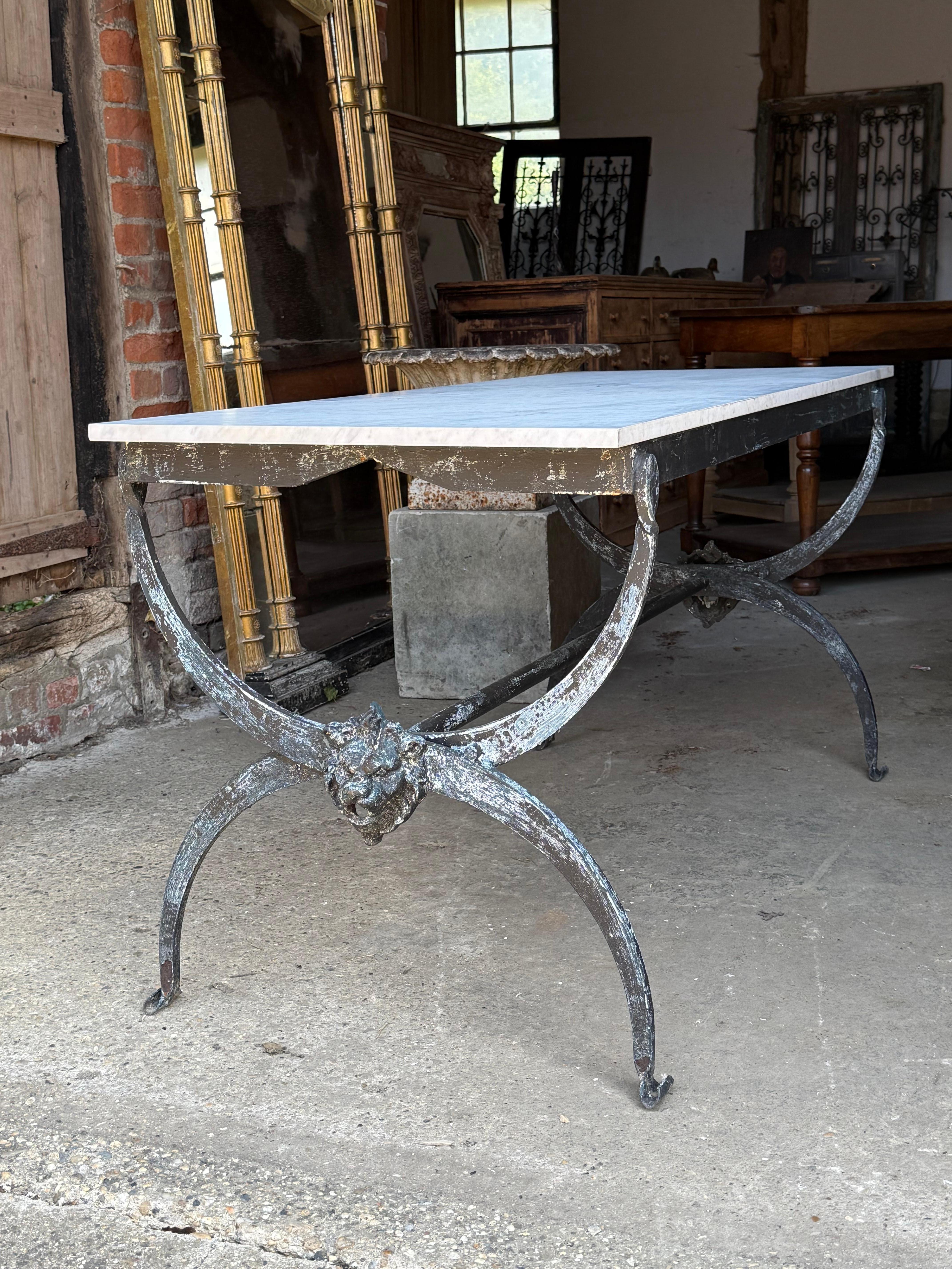 A lovely French butchers table with a wrought iron base and marble top. This originally came from a butchers shop in the south of France, where it would have been used to display fine cuts of meat in the shop. It would now make a wonderful