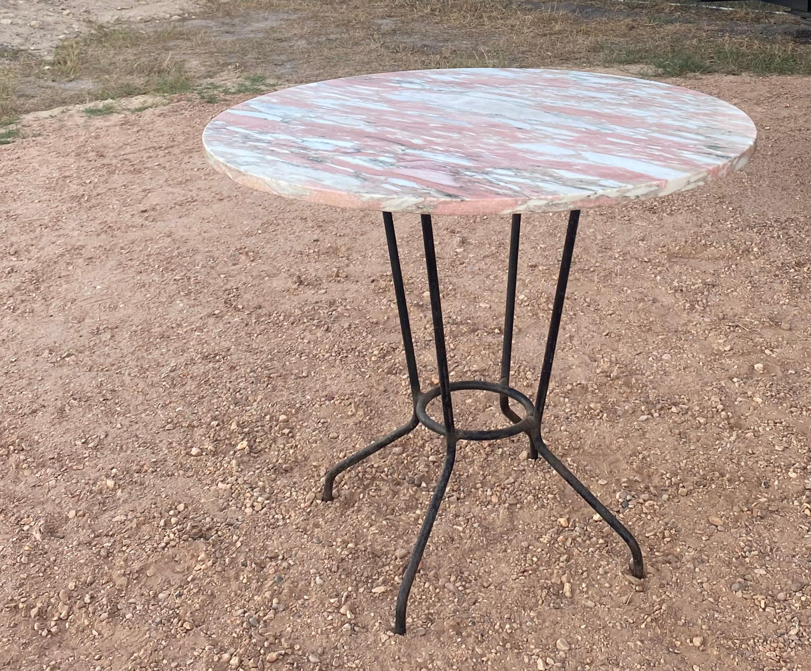 Round 1960s pink marble and French iron indoor or outdoor dining or patio table. Feminine and masculine are in perfect balance in this piece.

DIMENSIONS
36ʺW × 36ʺD × 29.5ʺH

This French garden bistro table is a unique and charming piece that will