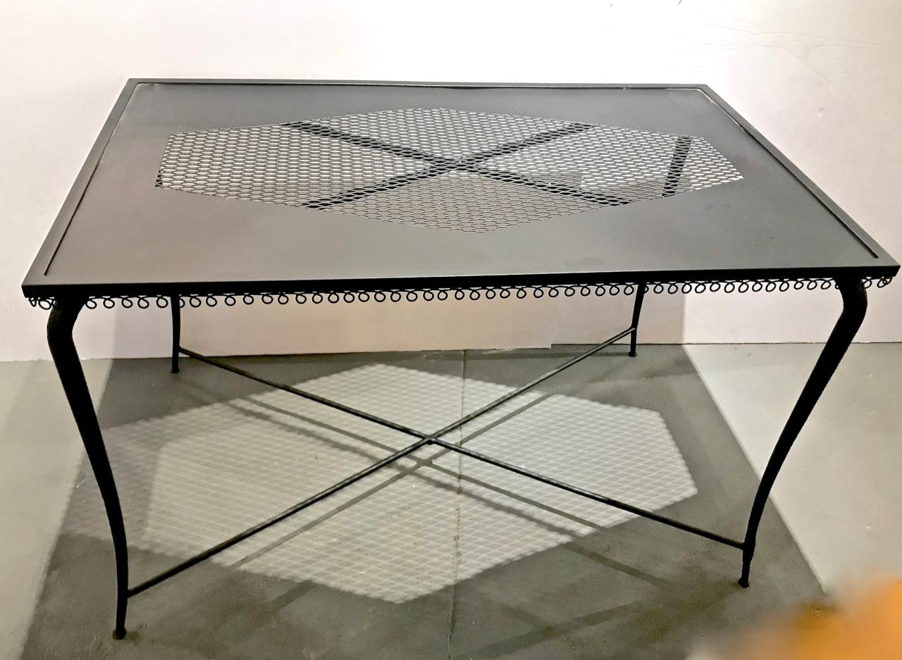 This is a great example of a French midcentury perforated iron table that is attributed to Matheiu Mategot. The sexy curvy legs combined with the scrolling trim give the table just the right amount of sophistication.. The table is newly refurbished.