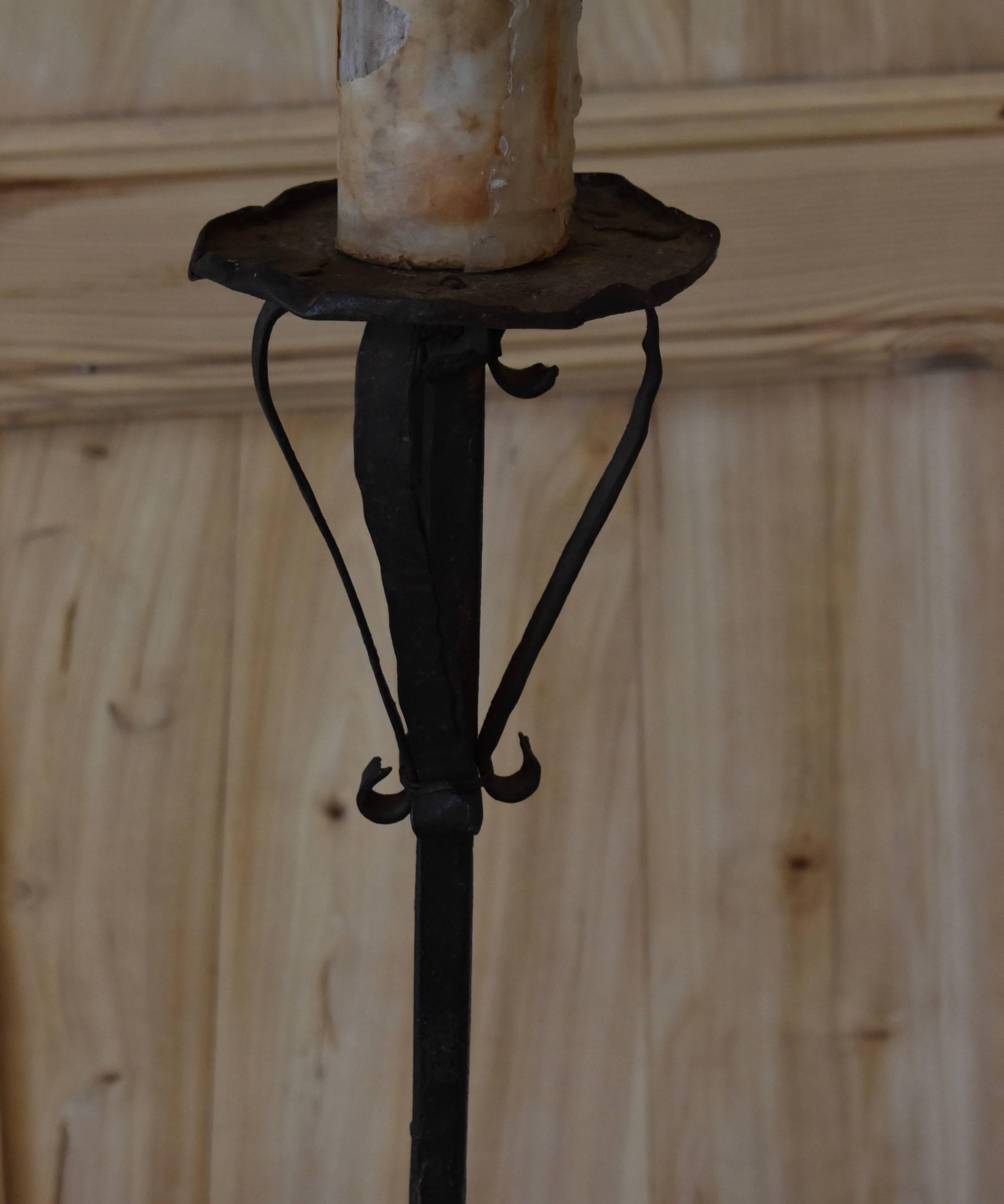 Great smaller French iron torchiere floor lamp with old aged iron patina. Simple scroll work design on stem and candle top. Measures: 47