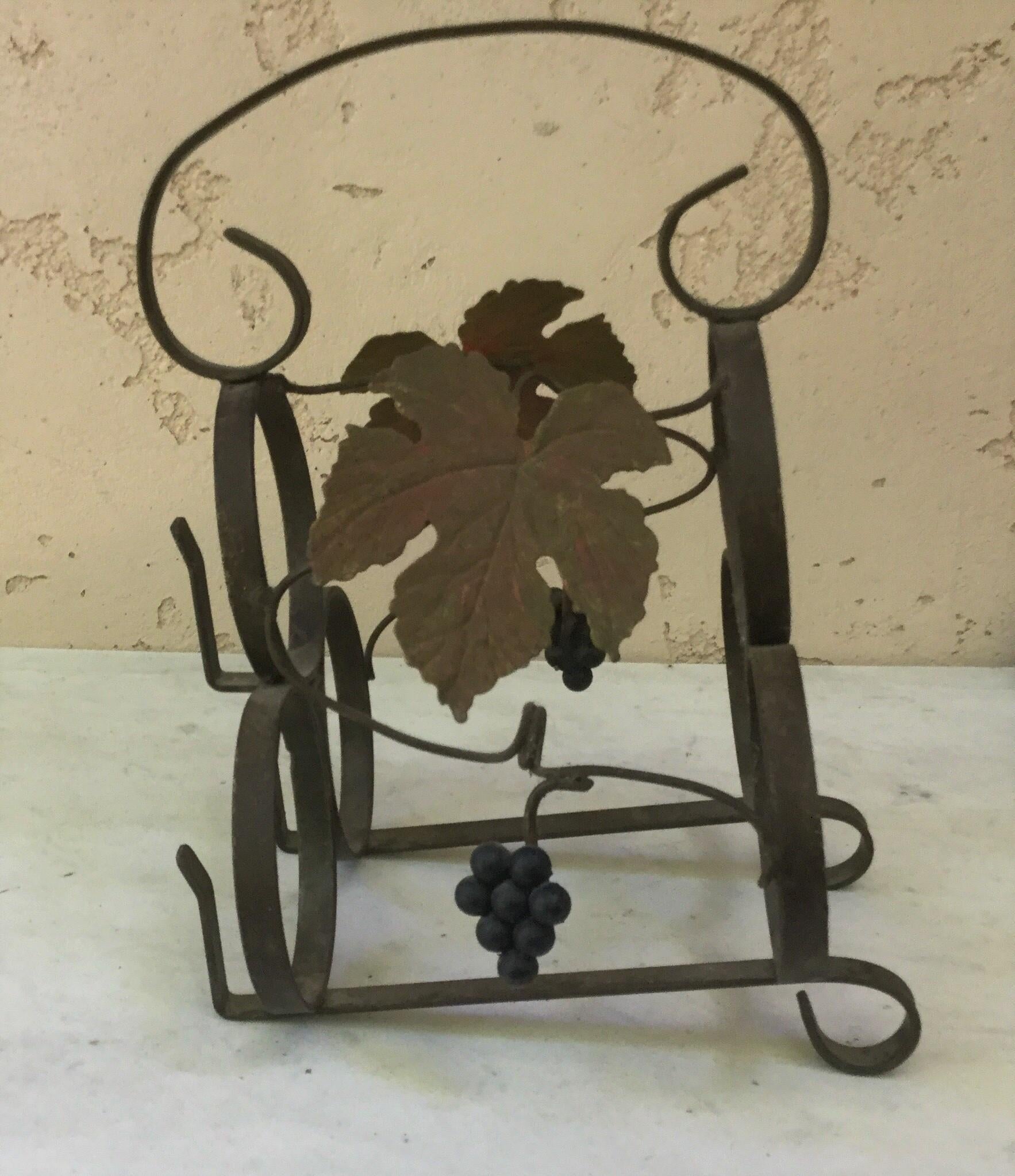 French iron wine bottle rack for 3 bottles decorated with grapes, circa 1950.