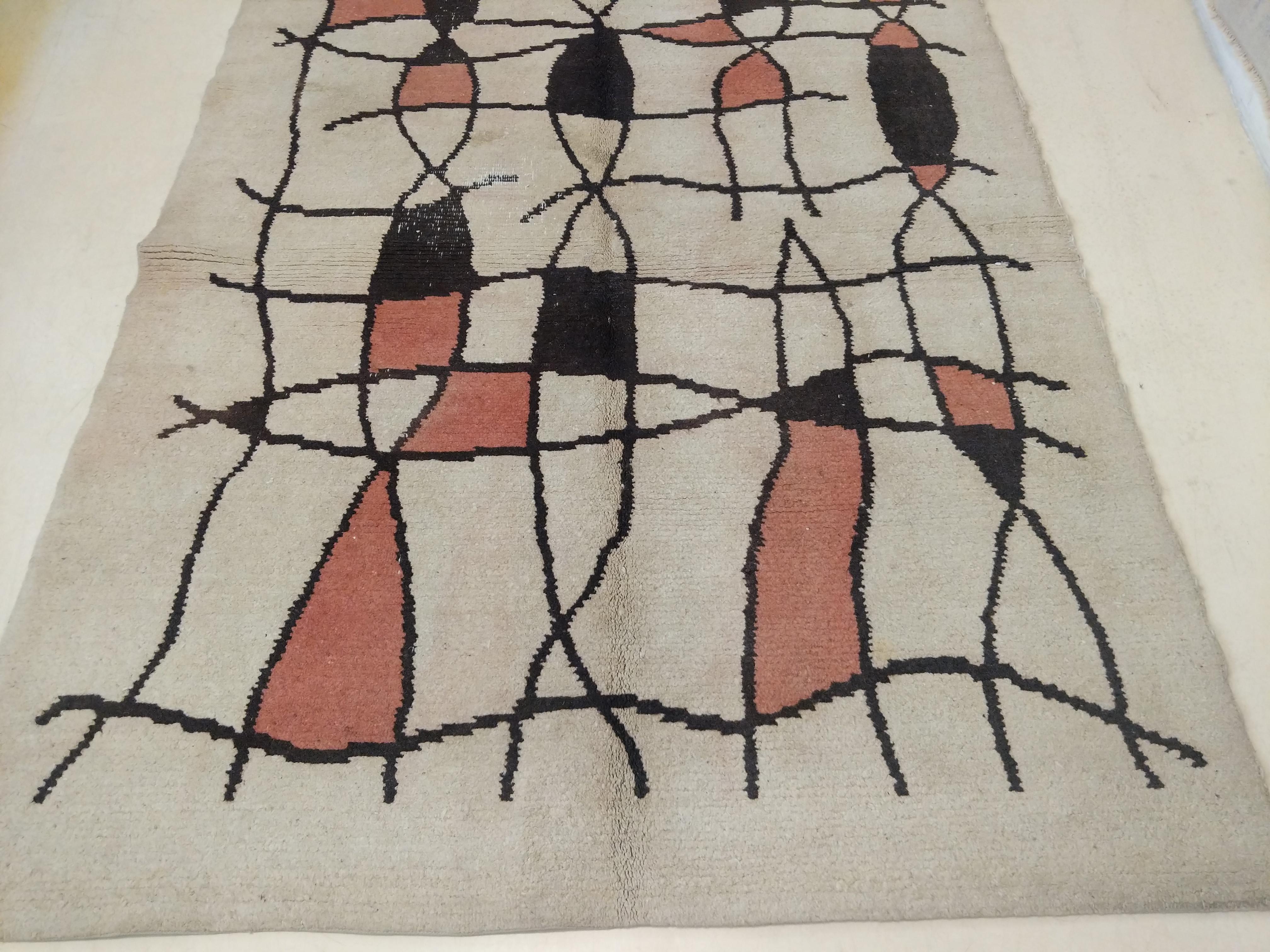 A rare and unusual French Art Deco rug distinguished by an abstract grid pattern over an ivory background. Rugs of this period were quite strongly influenced by the artistic avant-garde movements that were happening in Paris, as there was a strong