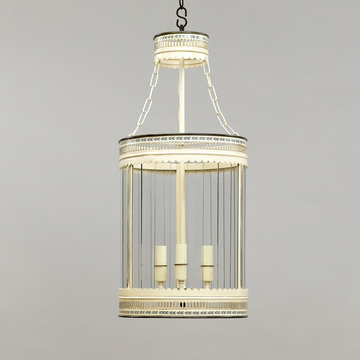 French Ivory lantern, based on a French design, the delicate hand-painted decoration on the slatted glass adds texture. The motif on the coronet is reflected in the decoration on the central body. The three-light lantern has a hand-painted steel
