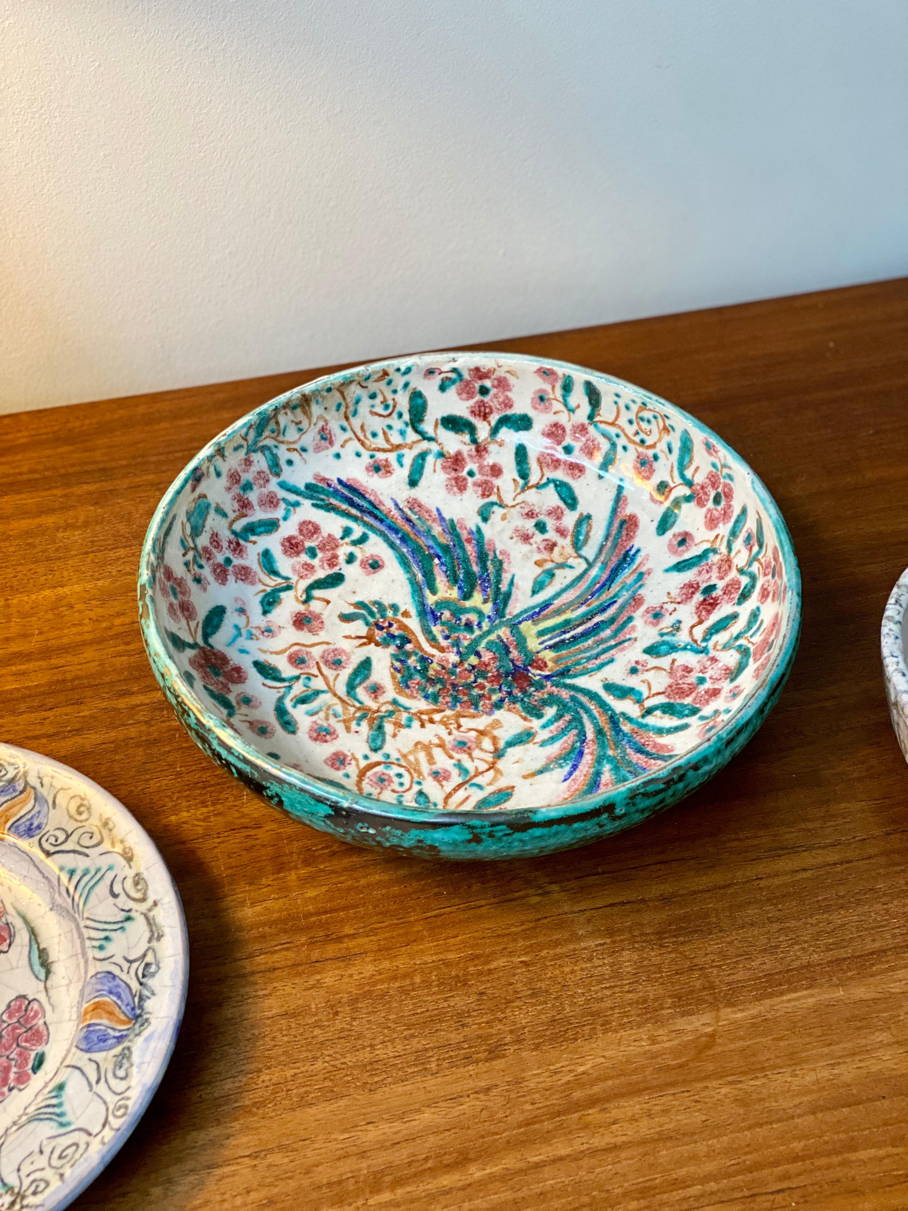 French Iznik-inspired ceramic bowl by Édouard Cazaux (circa 1930s). Master ceramicist, Édouard Cazaux was inspired by antiquities, religion and animal life in his creations. This magnificently decorated ceramic bowl displays an Iznik-styled phoenix