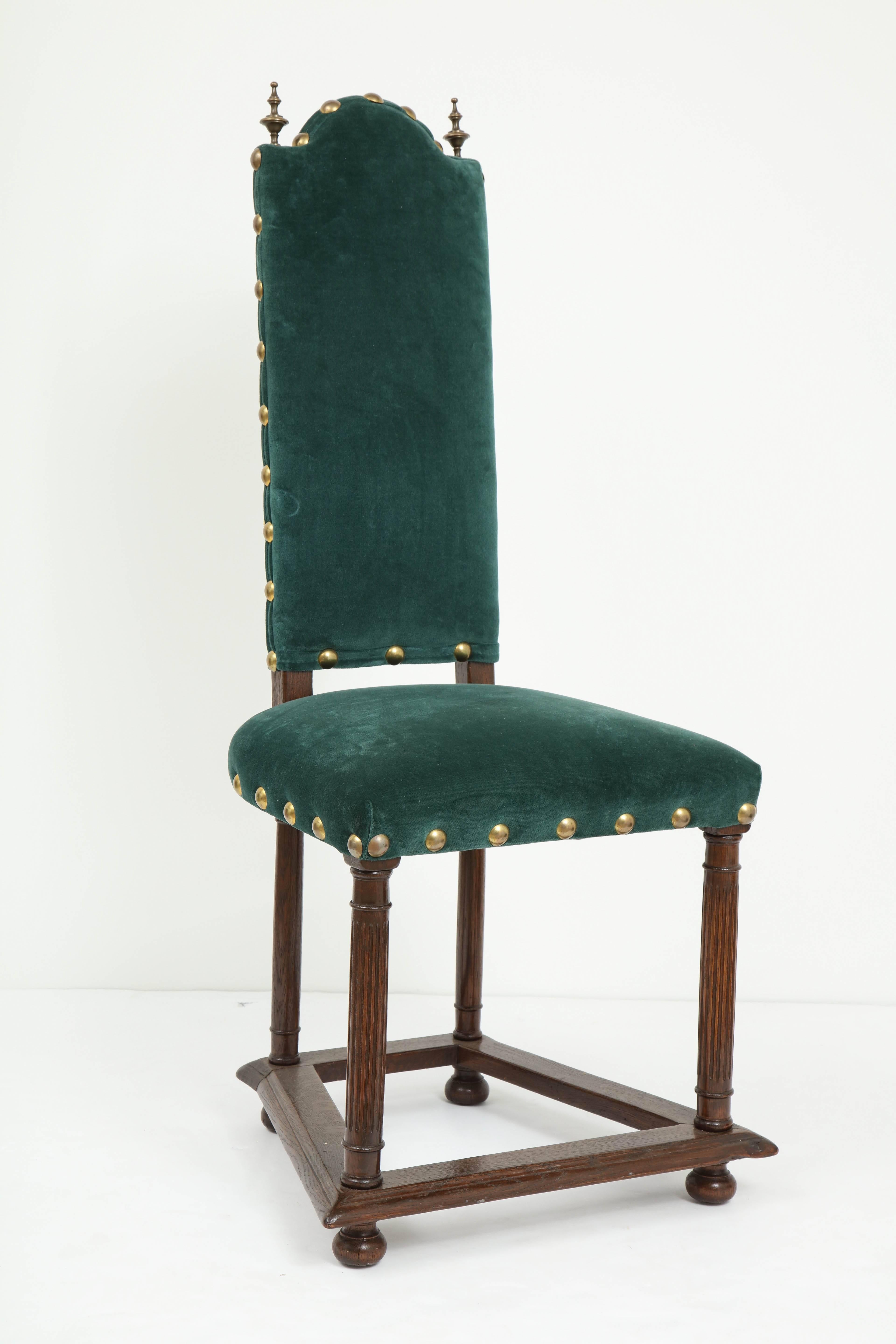 Pair of French Jacobean style side chairs with solid oak frames and upholstered in a blue or green moleskin velvet. Chairs feature bronze finials and large nailhead trim. Stamped, Made in France on bottom.