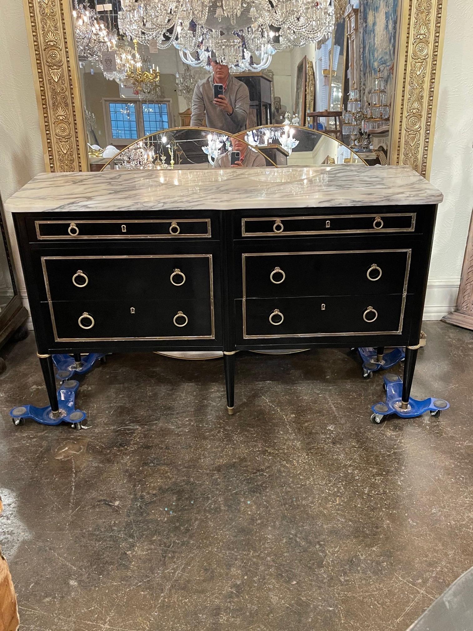 Lovely French Jansen style black lacquered dresser with marble top. Featuring a beautiful polished finish and pretty brass hardware. Fabulous!