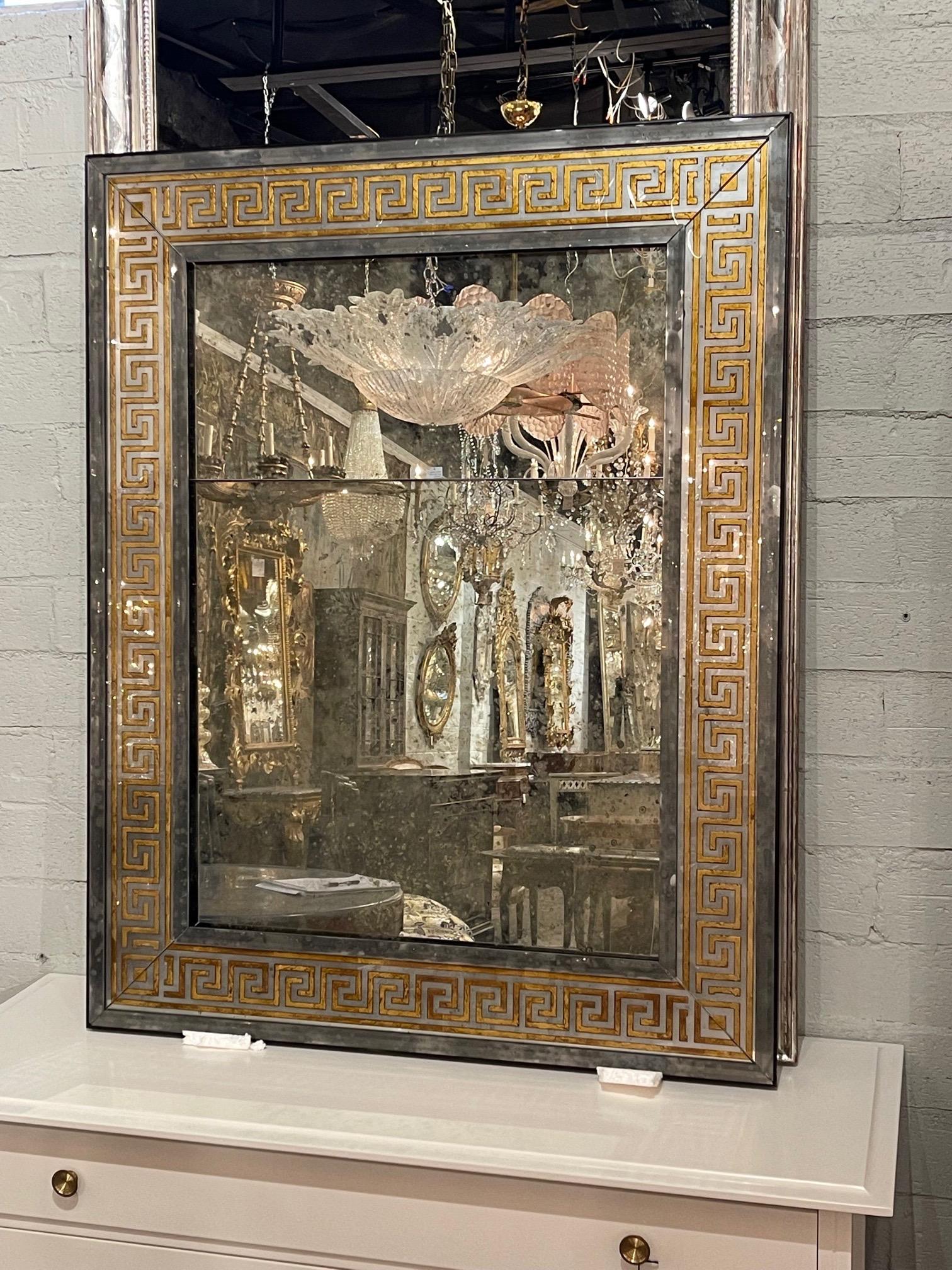 Fabulous French Jansen style distressed mirrors with eglomise Greek Key borders. Notice the divided glass on these and the beautiful patina! Makes a very stylish statement. Note price listed is per item.
Also there is a small crack on the top right