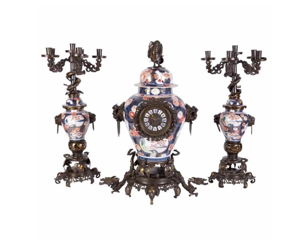A French Japonisme parcel-gilt patinated bronze and Japanese Imari Porcelain clock garniture, circa 1880.

In the manner of Edouard Lievre.

Mounted with bronze dragons and elephant heads, very finely made.

The clockworks stamped H. Sequin,