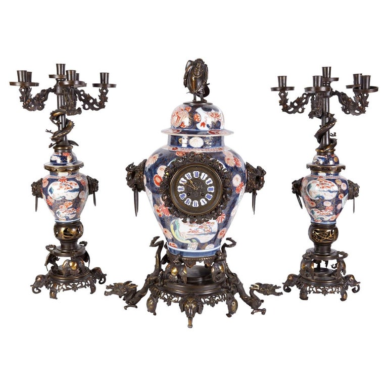 French Japonisme Parcel-Gilt Patinated Bronze Imari Porcelain Clock Garniture