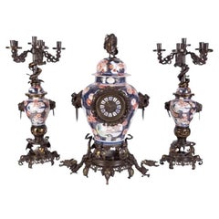 French Japonisme Parcel-Gilt Patinated Bronze Imari Porcelain Clock Garniture