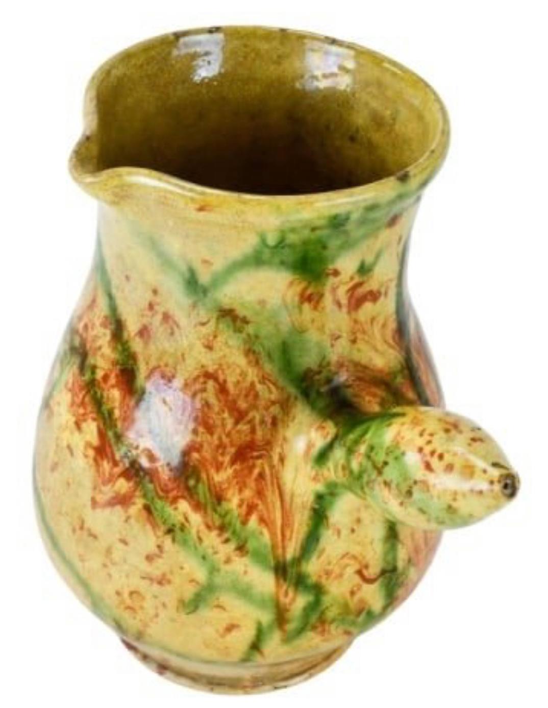 A 19th century French pitcher in terracotta with yellow and marbelized glaze from the Alps region, circa 1870. 