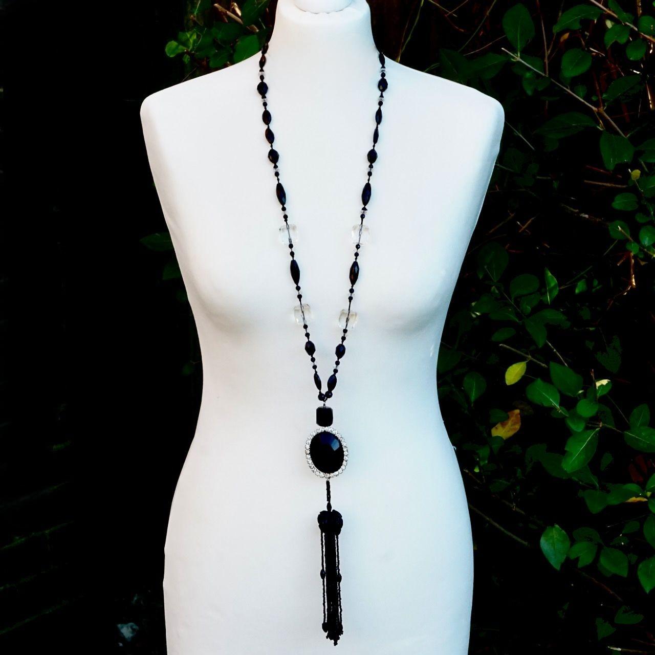 Fabulous long faceted french jet and clear beaded necklace, with an oval french jet and paste stone pendant, and ornate long beaded tassel. The necklace closes with a barrel clasp.  Measuring necklace length 93 cm / 36.6 inches. and the pendant and
