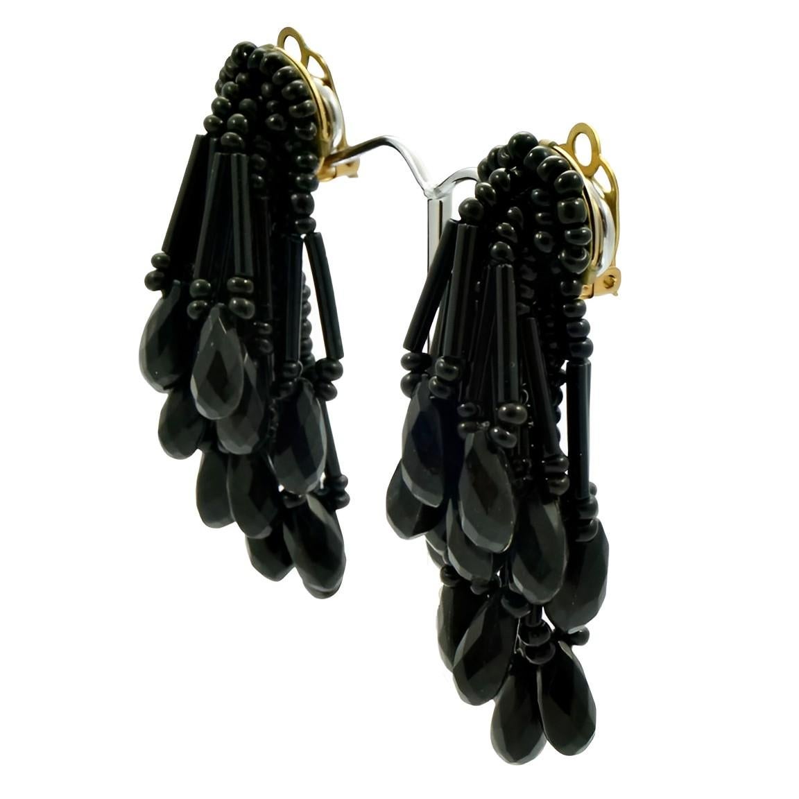 Fabulous french jet clip on earrings, featuring thirteen lovely beaded drops on each earring. Measuring length 6.2 cm / 2.4 inches. There is wear to the gold plating on the back of the clips.

This is a beautiful pair of classic 1960s black glass