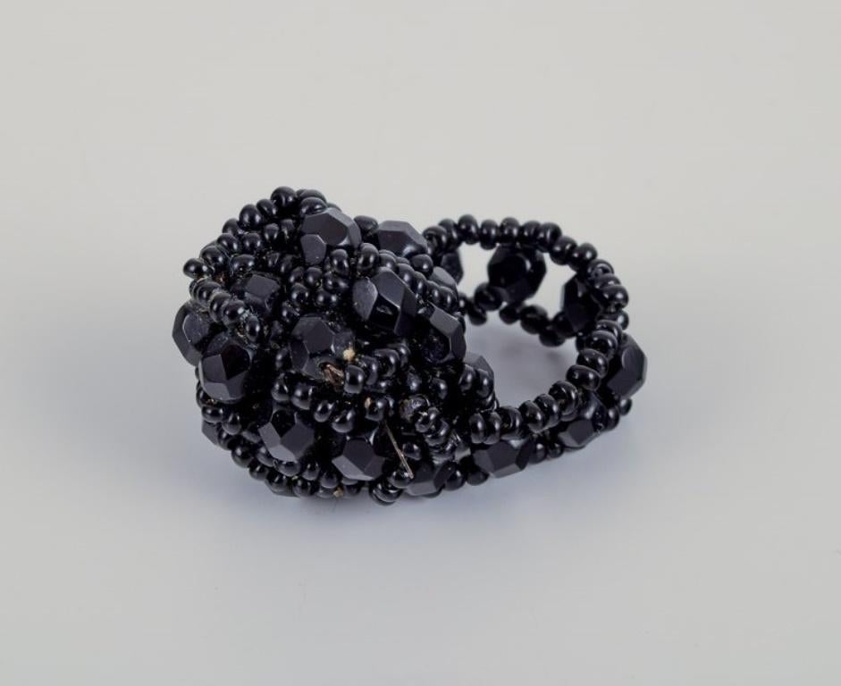 French jewelry artist. Five designer rings in plastic. 
Striped design with various colors and black beads.
1960s/1970s.
In excellent condition.
Dimensions: 17.5 mm - 19.0 mm.
US size approximately 7-9.