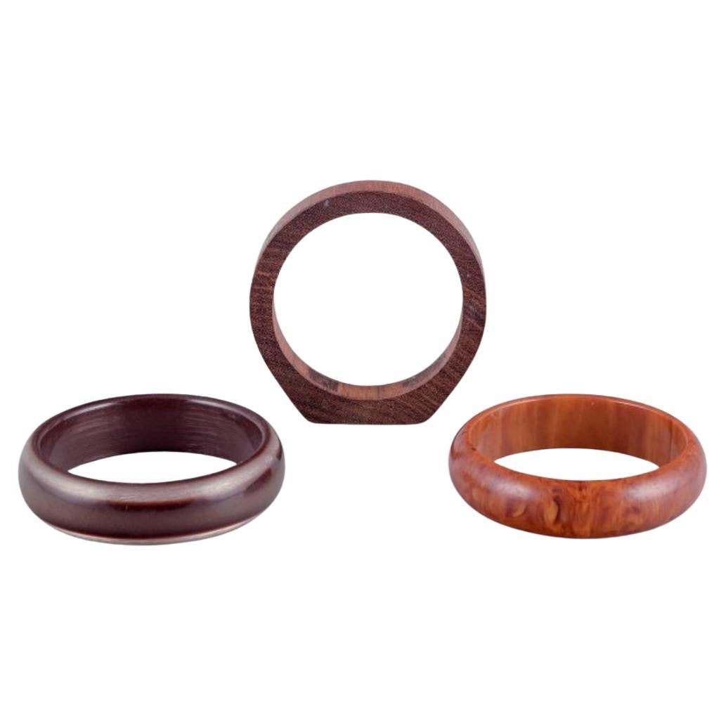 French jewelry designer. Three bracelets. Two in plastic and one in wood.