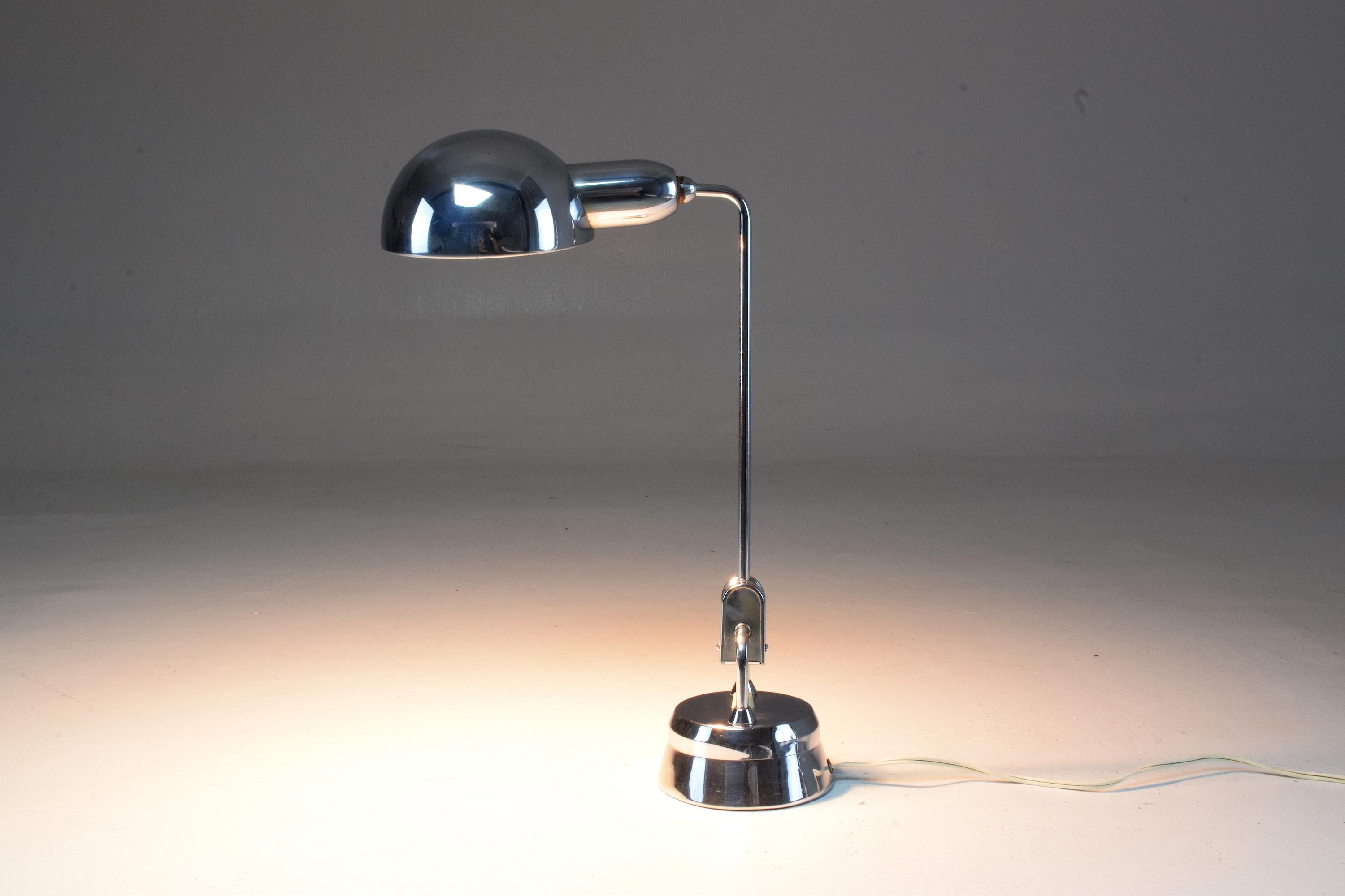 20th century vintage desk, office or bedside table lamp designed by Charlotte Perriand for Jumo composed of a chrome steel structure, semi sphere shade, pivotal tubular stem and light switch at the round base. 
Marked 600 at the base.
  