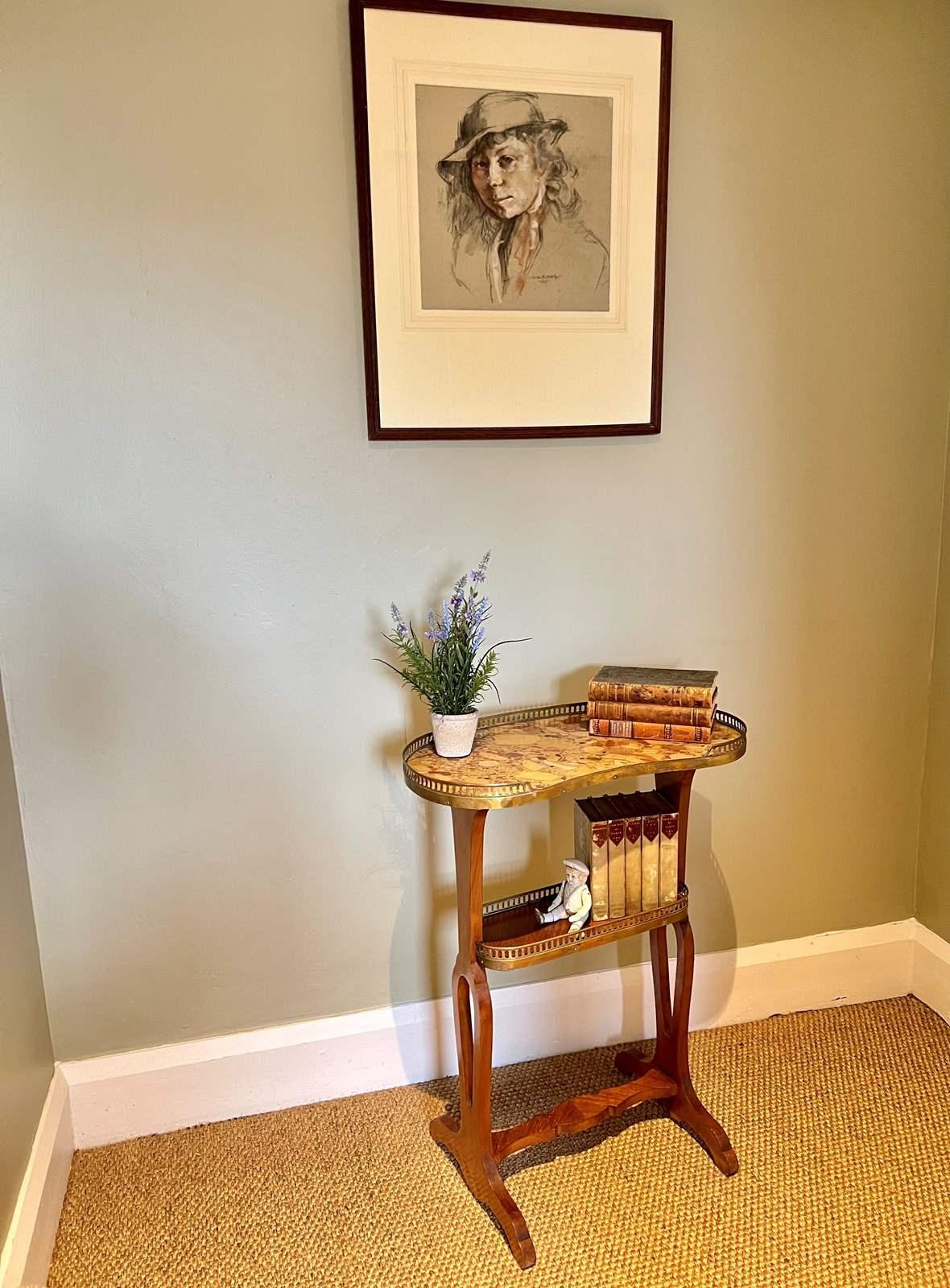 A pretty French Kidney Shaped Table. Having a composite marble effect top with a pierced brass gallery.

Lower oval book shelf with gallery and book-matched veneers.

Standing on smart supports joined by a carved stretcher.

Ideal as a side, lamp,