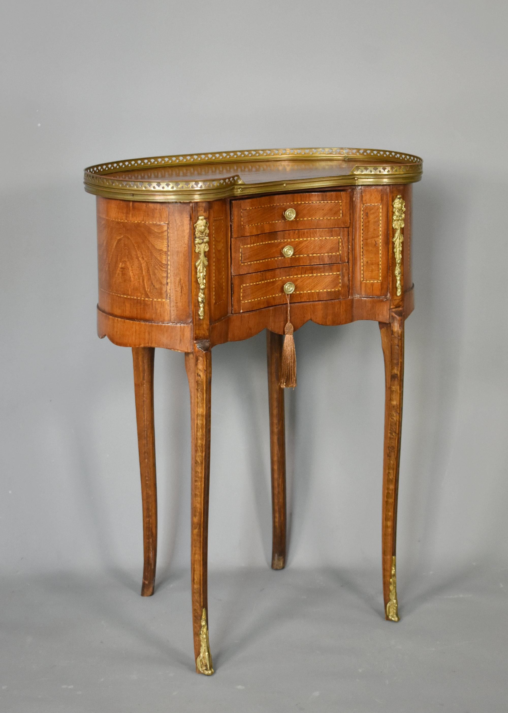 French Kidney Shaped Side Table Louis XVI Style
 
A delightful kidney-shaped side table featuring inlaid panels of burr elm framed by dotted stringing lines.
 
The top has a pierced brass gallery and below are three serpentine fronted drawers, each