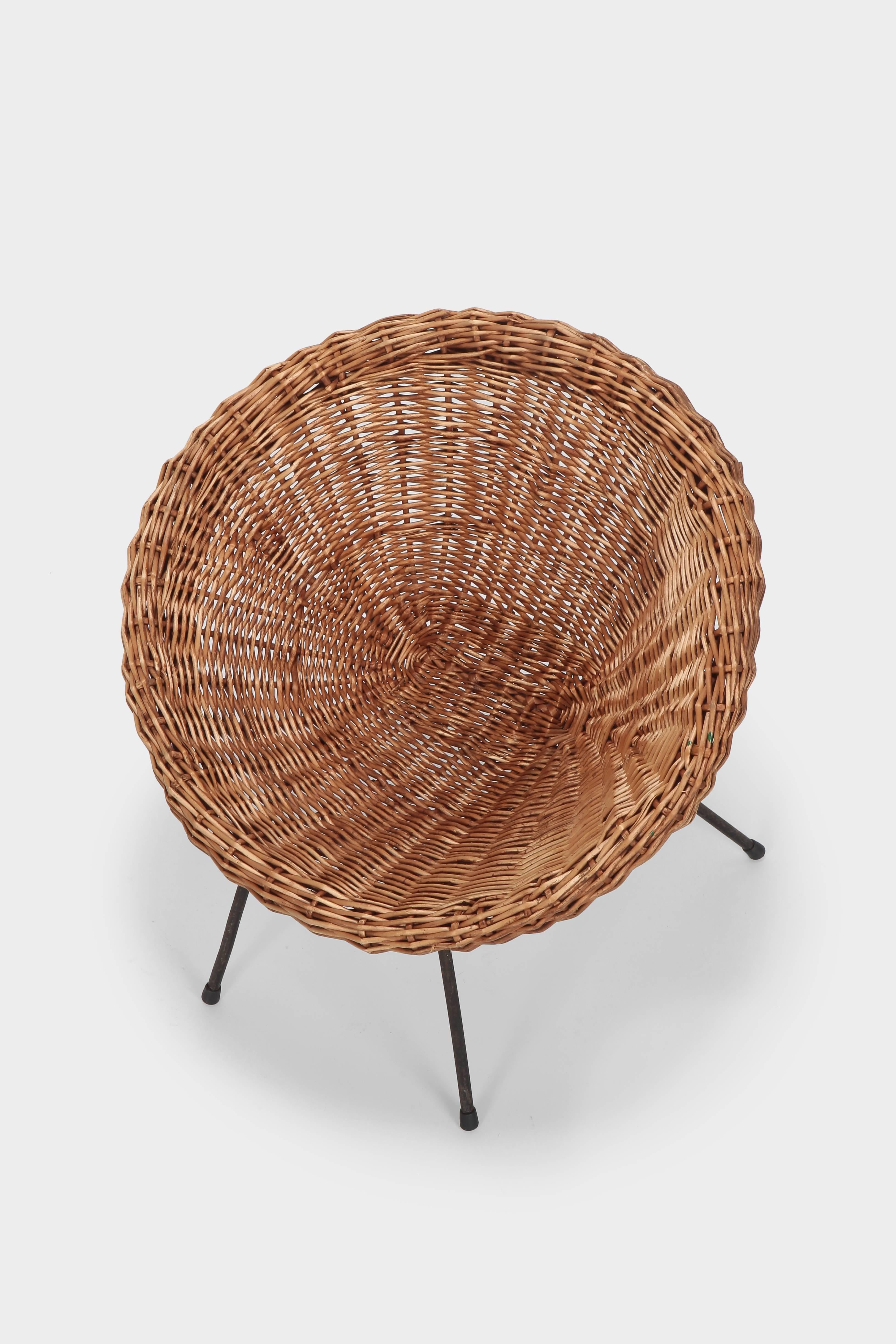 French kid’s wicker chair manufactured in the 1960s. Hopper shaped wicker on a minimalist black lacquered steel frame.