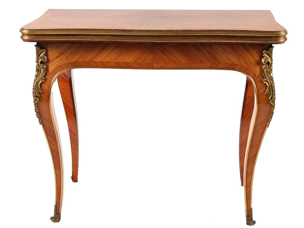Early 20th century French kingwood turn over top card table.

The rear legs pull-out with a drawer action to support the tabletop when opened.

The table stands on four cabriole legs terminating in ormolu scroll feet.

Each leg has shaped