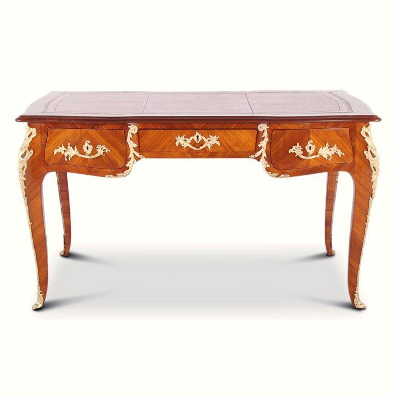 A very fine and well-proportioned French ‘Bureau Plat’ or writing desk, the case veneered in book-matched kingwood and embellished with finely cast and finished gilt bronze mounts. The desk is fitted with three drawers to the frieze and three ‘faux’