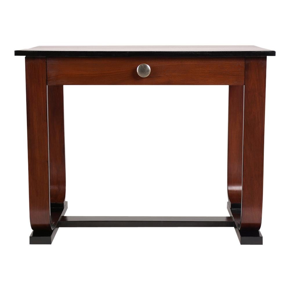 This 1960's French Art Deco Writing Table has been completely restored, is made out of mahogany, and has been stained a rich mahogany & ebonized color combination with a newly lacquered finish. This side table comes with a single top drawer with a
