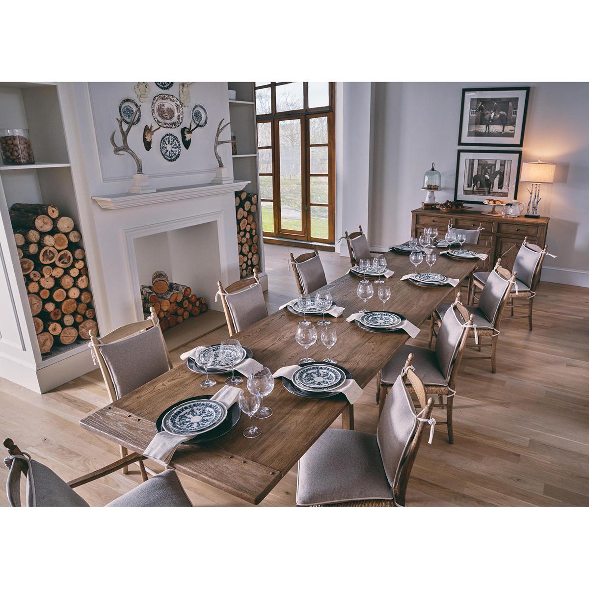 This chair boasts a robust stripped chestnut finish to the frame that reveals the exquisite natural grain and charm of the wood, evoking a sense of traditional beauty. Wrapped in creamy oatmeal performance fabric cushions, the chair combines plush