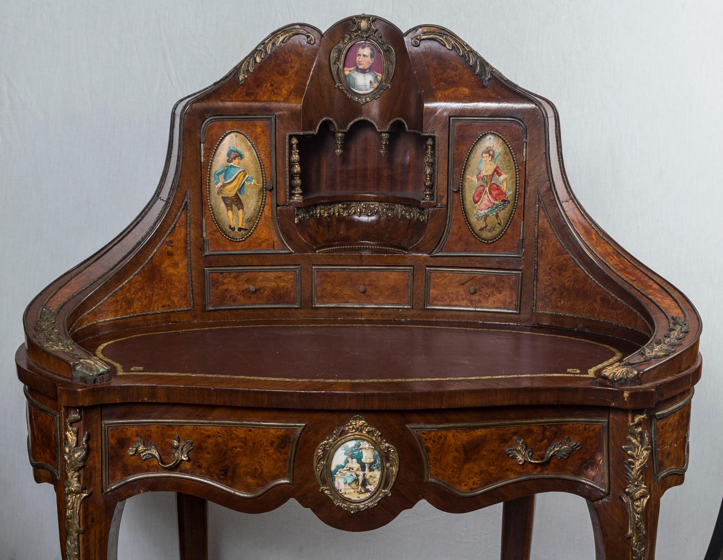 In the Louis XV style, a curved lady's desk with brown leather and gold tool work.
One long drawer below the writing surface. Three short drawers at the writing surface. The writing surface area measures 14 x 29. It is 32 inches off the floor with