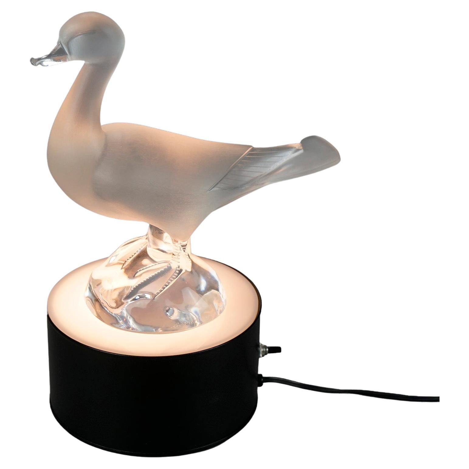 A French duck sculpture by Lalique offers standing duck on lighted base, signed, 20th century

Measures- overall 13.5''H x 9''W x 6.75''D; duck only 9.5''H x 4.25''W x 9.25''L; pedestal only 3.5''H x 6.75''Diam