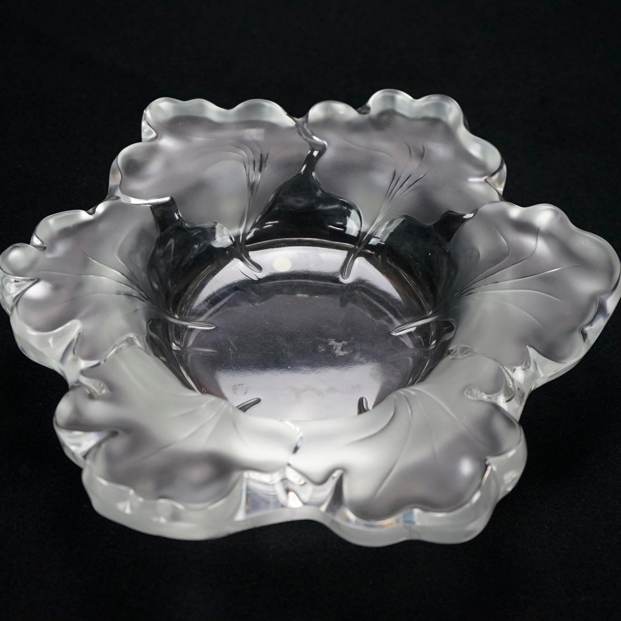 A French center bowl by Lalique offers art glass construction with leaf form rim, maker signed as photographed, 20th century

Measures- 2.5''H x 12.25''W x 12.25''D.