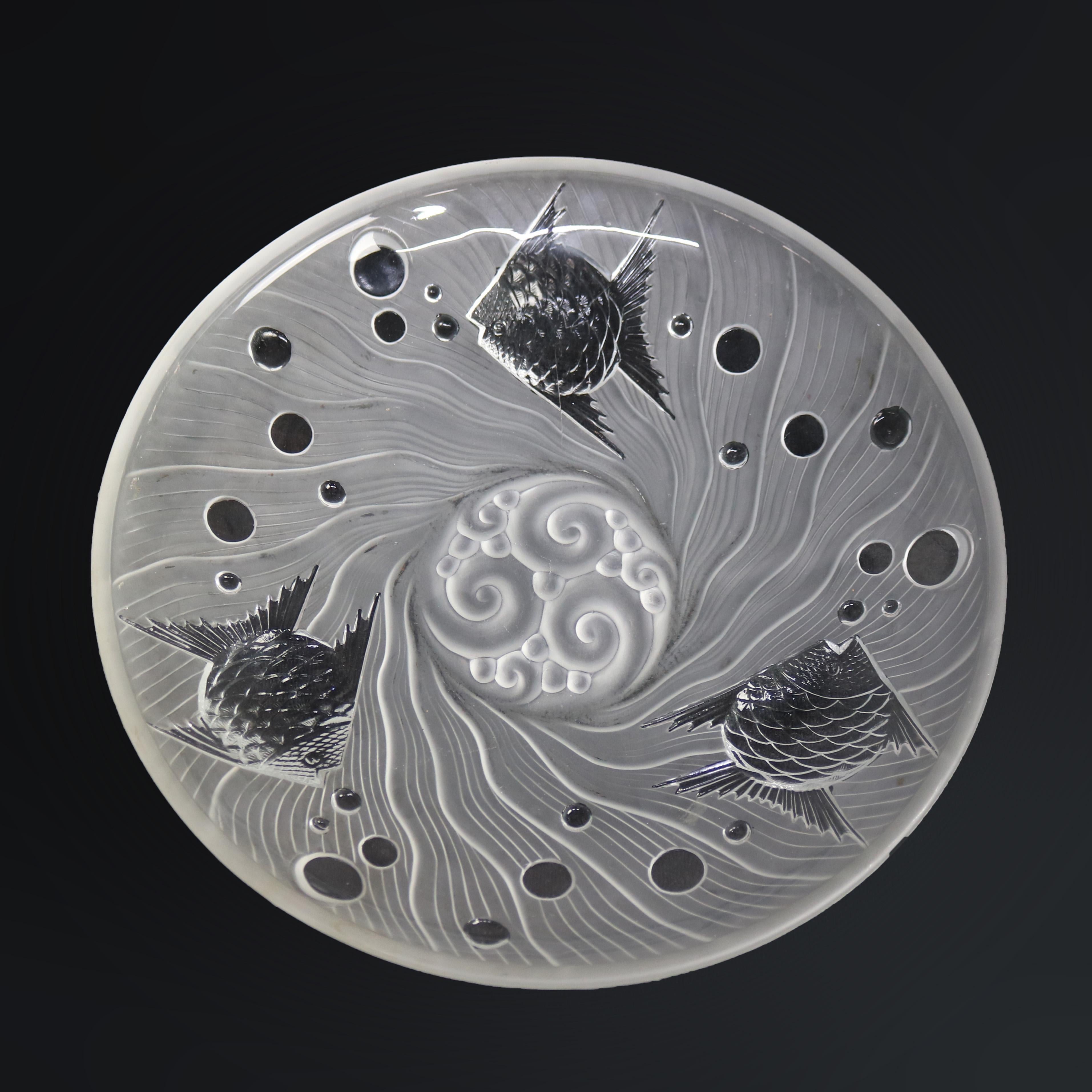 A French center bowl in the manner of Lalique offers art glass construction with stylized under sea scene including fish, waves, and bubbles, unsigned, 20th century

Measures - 2.5''H X 14''W X 14''D.