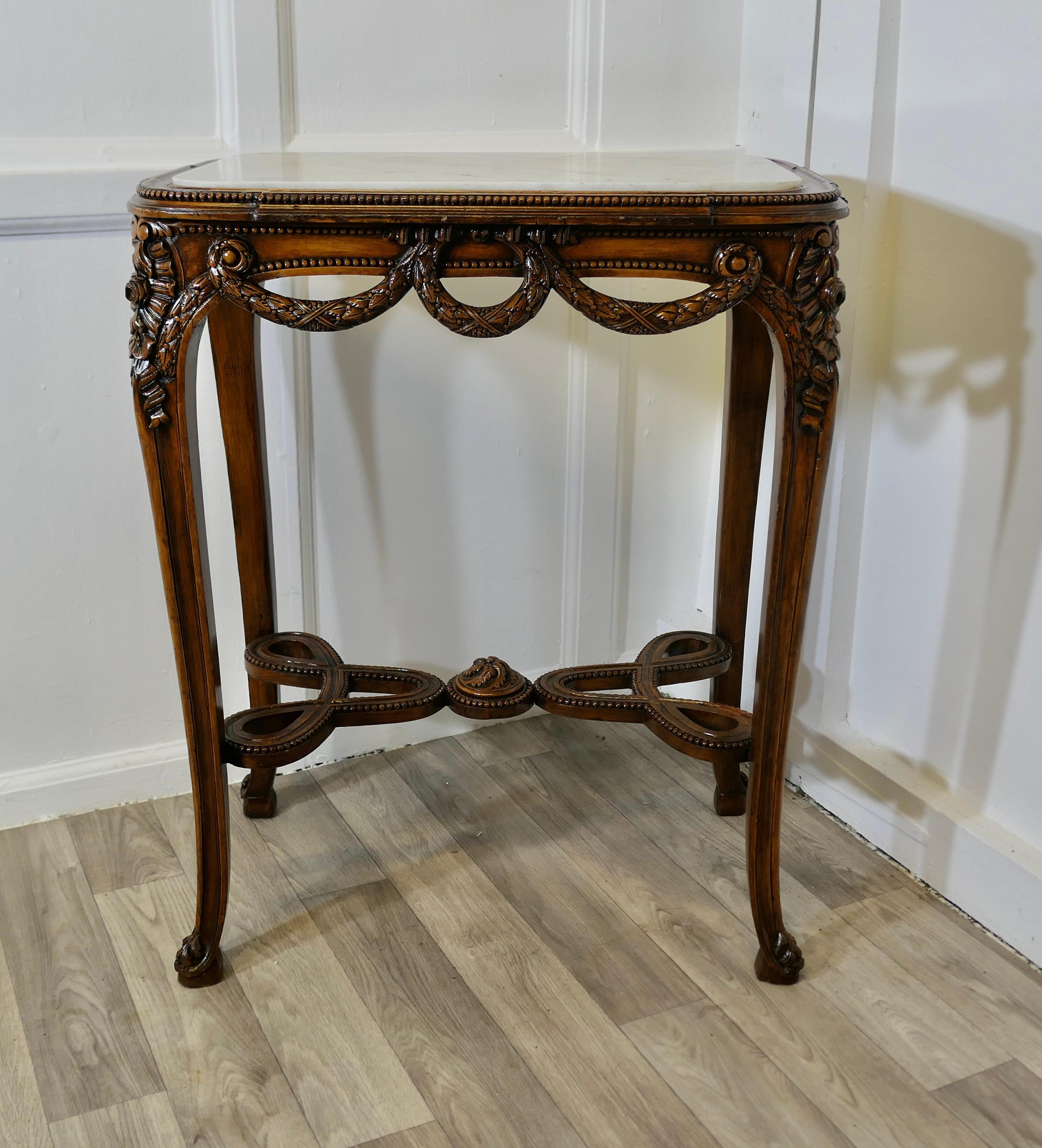 French Lamp Table with Carved Decoration and Marble Top

This is a superb quality French side table, the table has a rectangular shape, the top has and inset Marble, the legs and stretchers have very elaborate carving in the form of ribbons and