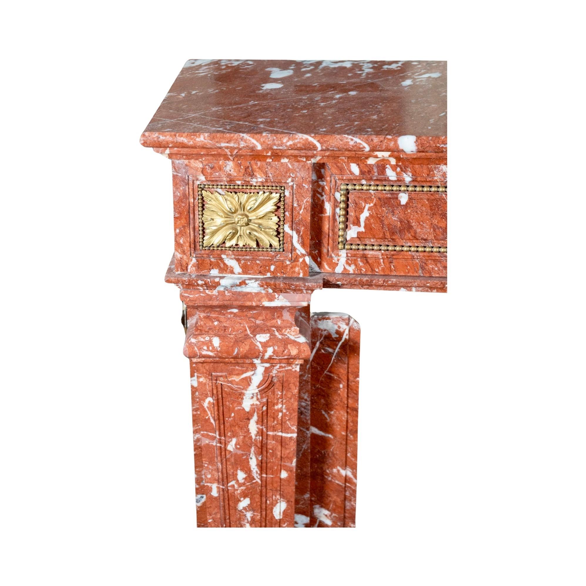 This antique mantel, made from rare Languedoc Red Marble, hails from France in the 1850s. It offers unique character and durability, along with a side vent for added functionality. Perfect for elevating your fireplace and adding a touch of classic