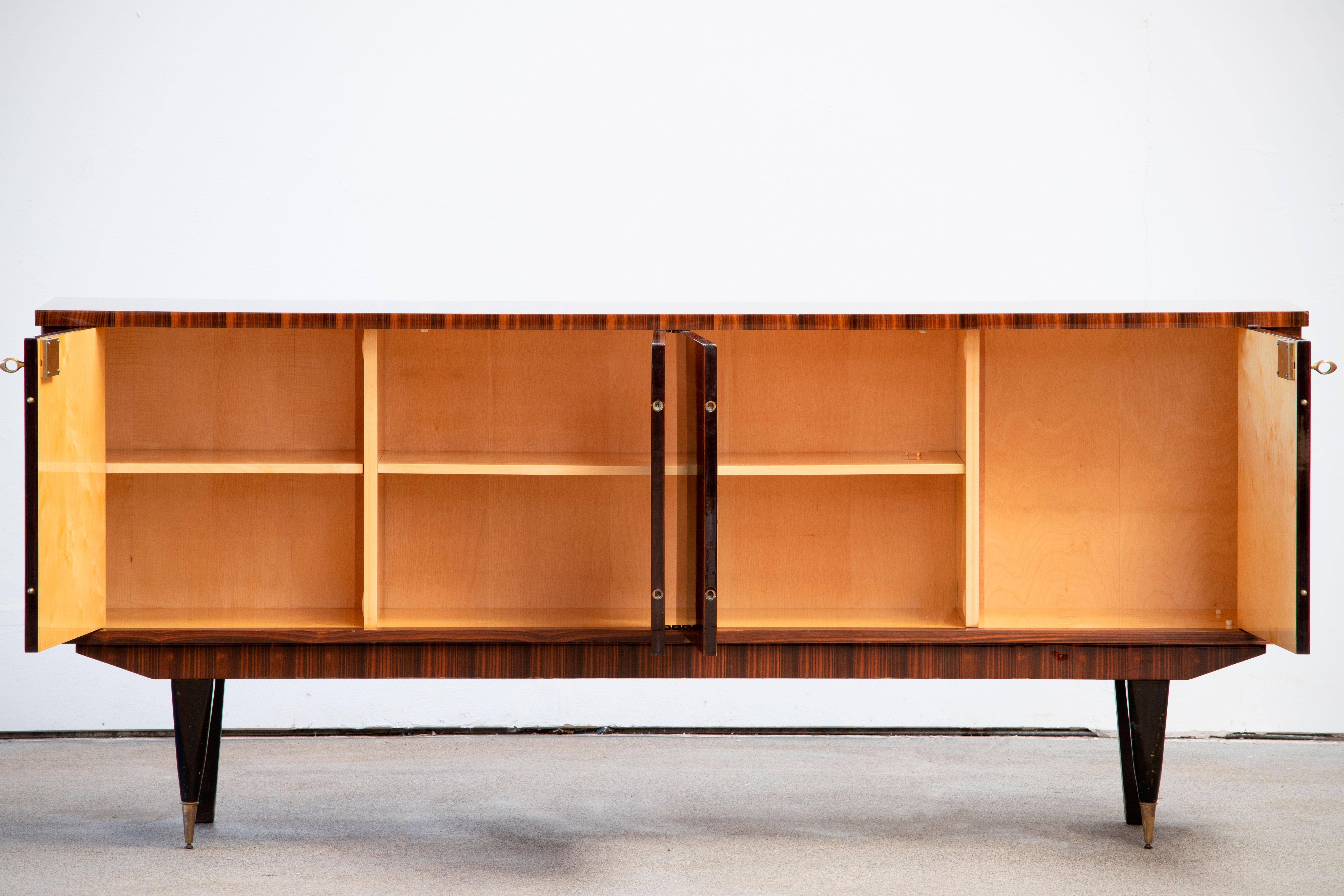 French Art Deco sideboard, credenza, with bar cabinet. The sideboard features stunning Macassar wood grain with a chess pattern in the center. It offers ample storage, with shelve behind the doors. Both sides of the cabinet lock, and two original