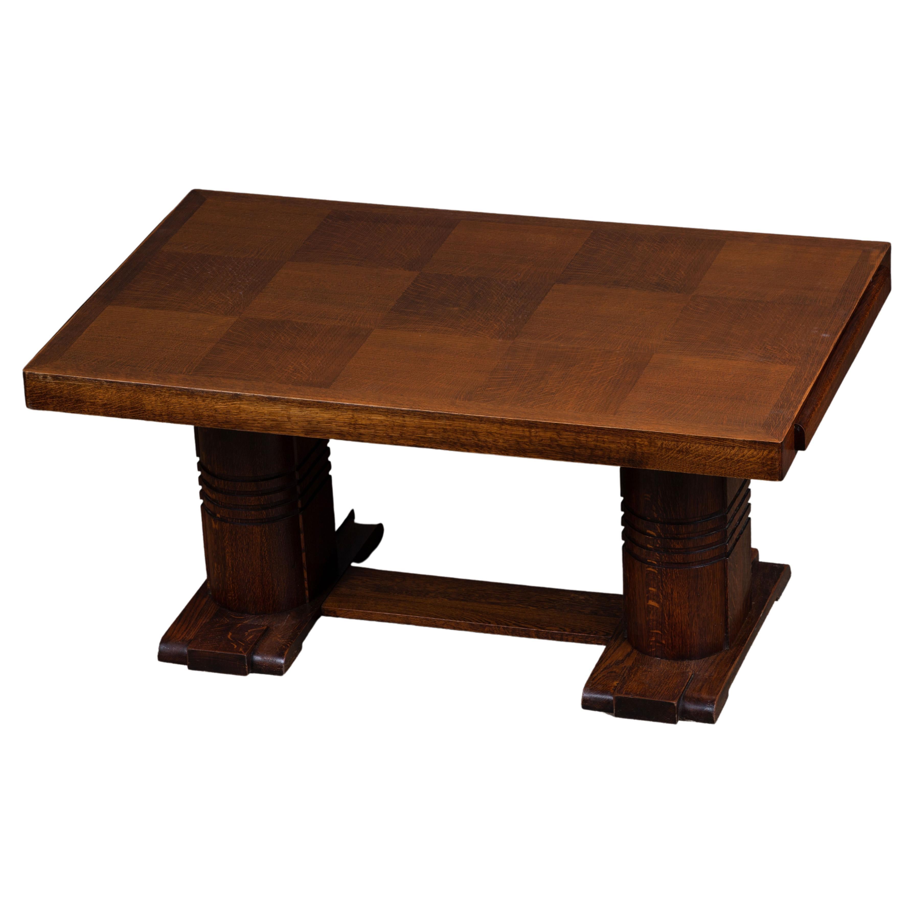 French Art Deco dining table. The table features stunning oak sanded wood grain with a stunning patina. The top is encrusted with a marquetry of diamonds. It rests on tall and Brutalist tapered legs.
The table is in excellent original condition,