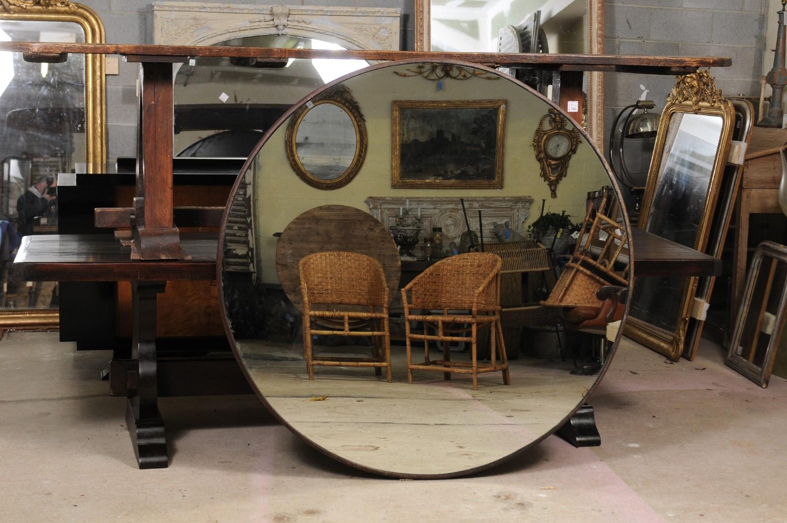 A contemporary French industrial circular mirror from the 21st century with iron frame taken from a car wash. When we tell you where this huge round mirror with its original and handsome frame came from you will be amazed: a French car wash! We know